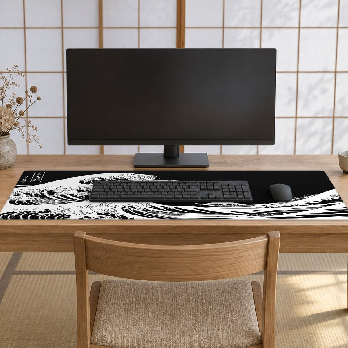 A calm Japanese-style room with paper-screen windows letting in soft morning light, a pale ash wood desk and chair, and a large black and white Great Wave desk mat spread across the desk.