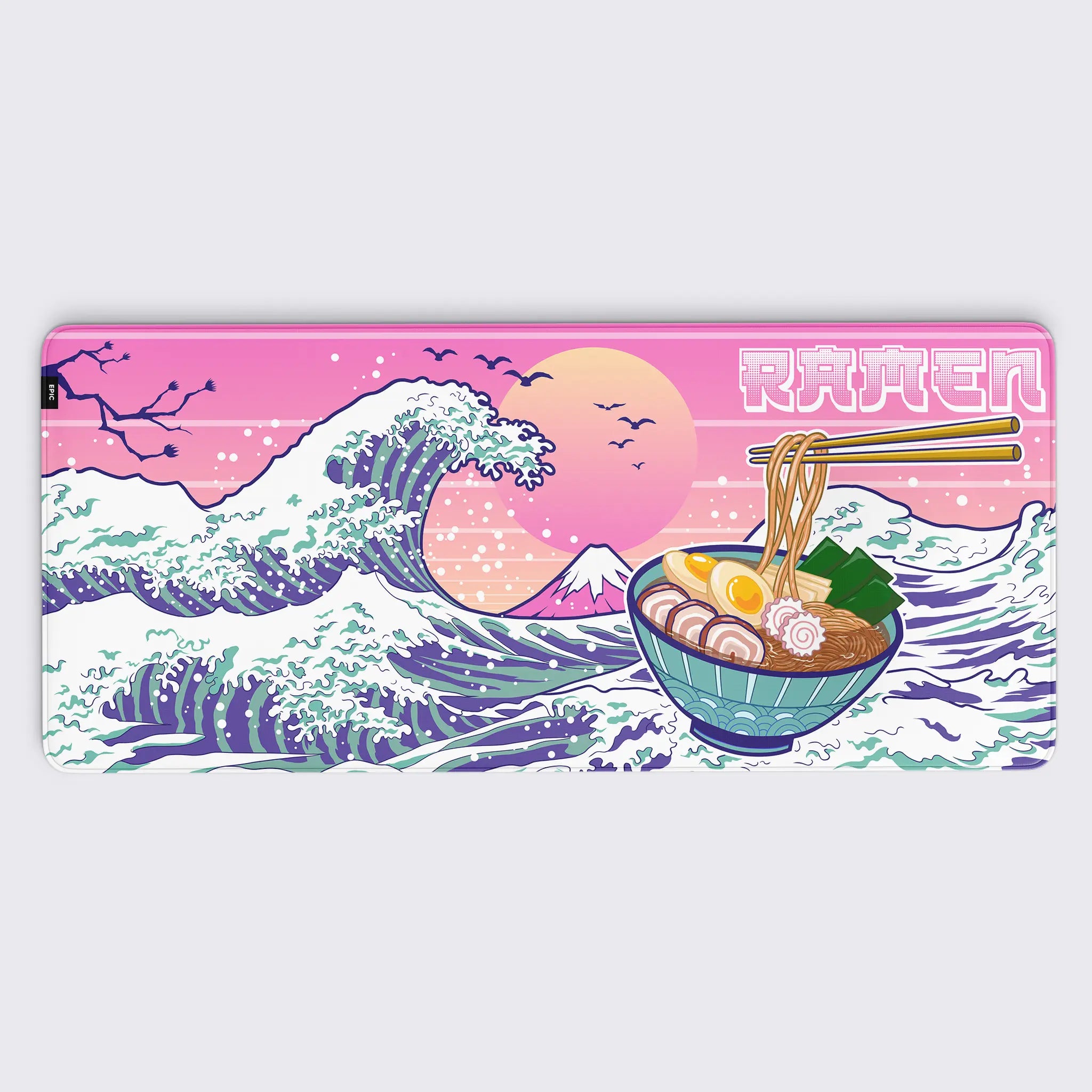 combines the iconic style of The Great Wave off Kanagawa with a playful ramen theme. A steaming bowl of ramen, complete with chopsticks lifting noodles, sits prominently amidst dynamic ocean waves, all set against a soft pink and orange sunset. The design exudes a mix of Japanese tradition and modern pop art, making it a unique and cheerful addition to any desk setup.