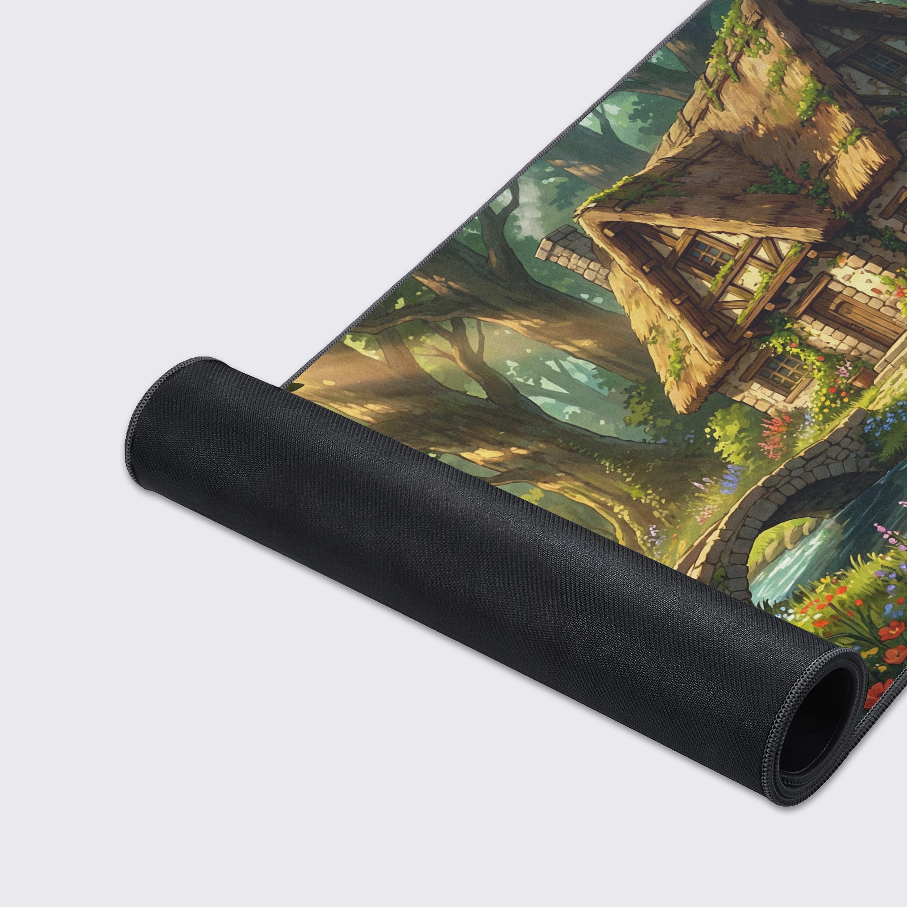 Close-up of the Enchanted Mill mouse pad, highlighting the high-quality fabric texture and durable stitched edges. The vibrant artwork of the water wheel and flowers is clearly visible. - Epic Design Pads & Mousepads