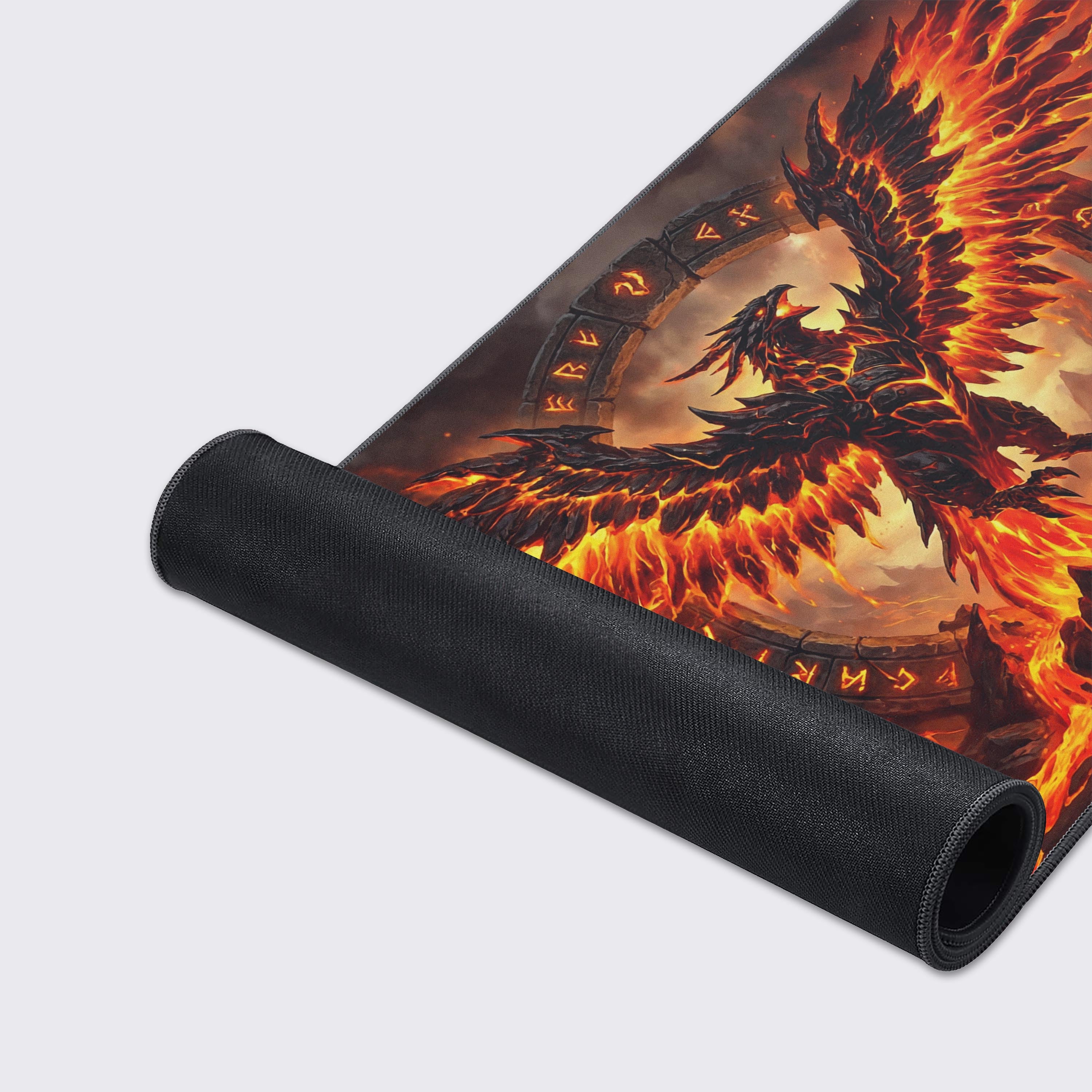 Close-up of the Infernal Rise gaming desk mat showing the smooth fabric texture, stitched edges, and the detailed volcanic phoenix artwork. - Epic Design Pads & Mousepads