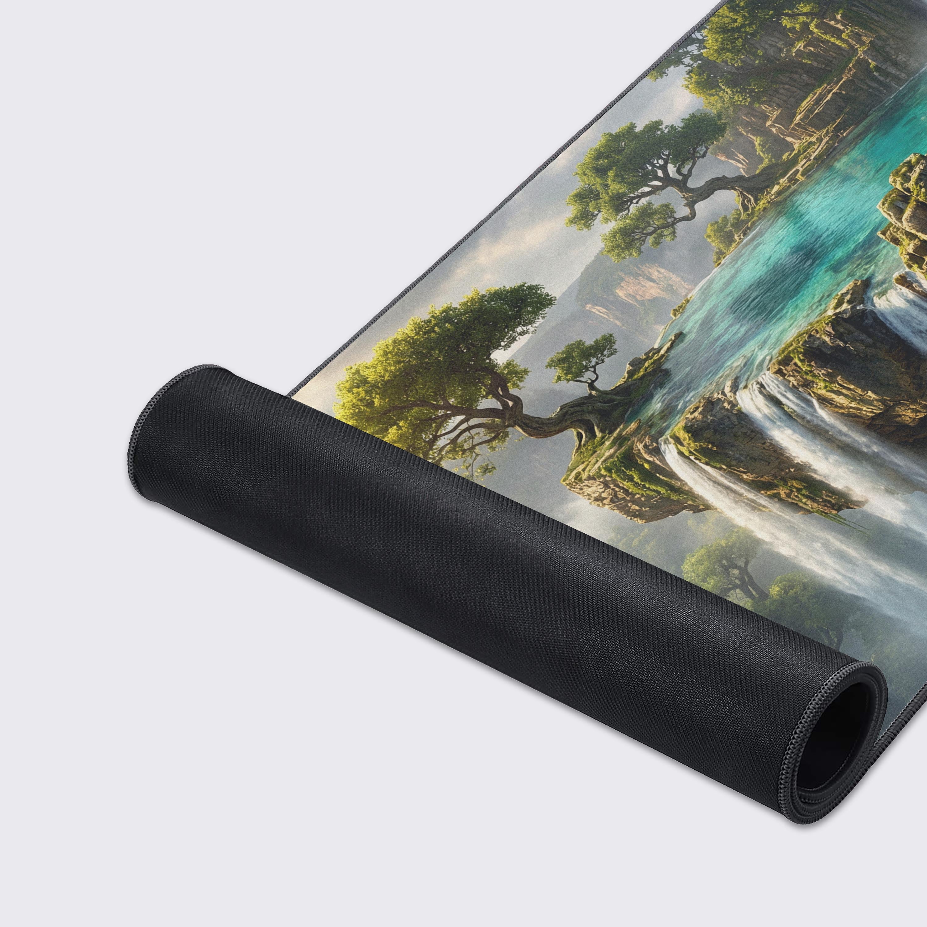 A close-up of the Emerald Cascade gaming desk mat highlighting its smooth texture and durable stitched edges, with the beautiful fantasy waterfall artwork in sharp detail. - Epic Design Pads & Mousepads