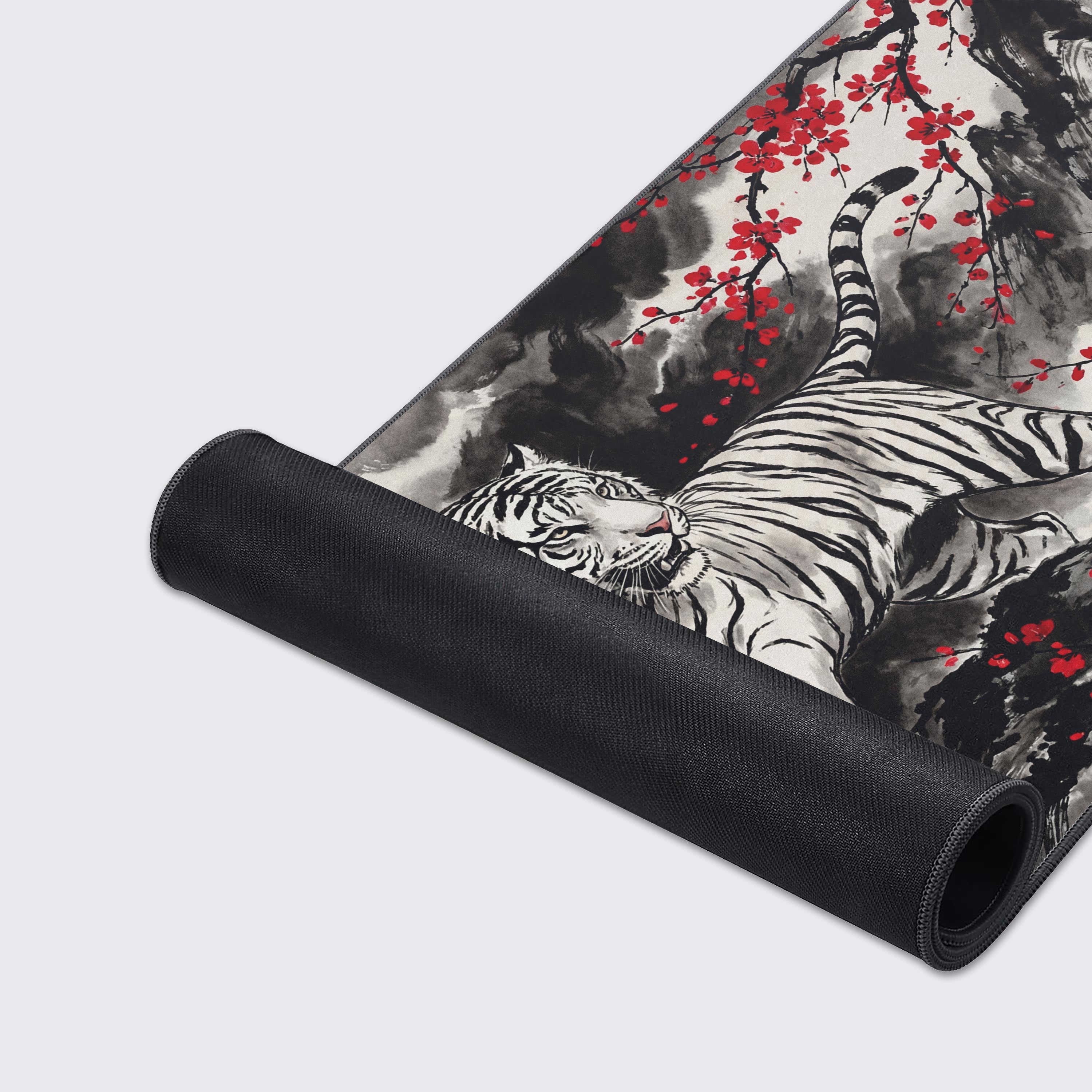 Close-up of the Crimson Tiger gaming desk mat's premium textured surface and durable stitched edges, highlighting the detailed ink wash art of the tiger and red blossoms. - Epic Design Pads & Mousepads