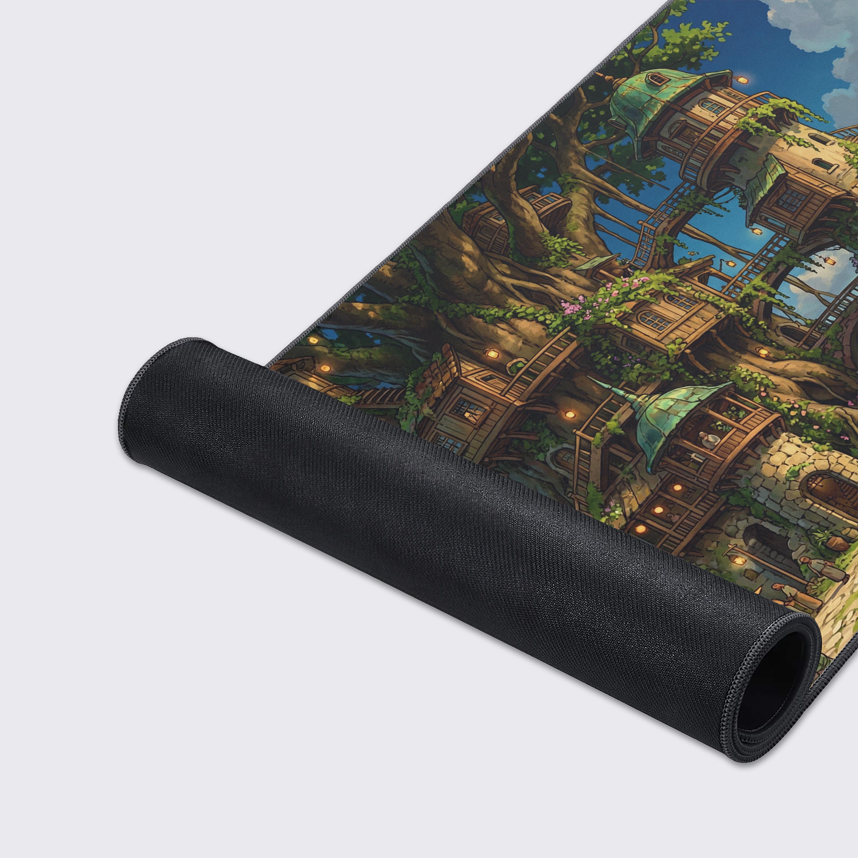 A close-up of the Sylvan Heights Gaming Desk Mat, showcasing the high-quality fabric texture and durable stitched edges of the enchanting treehouse village illustration. - Epic Design Pads & Mousepads
