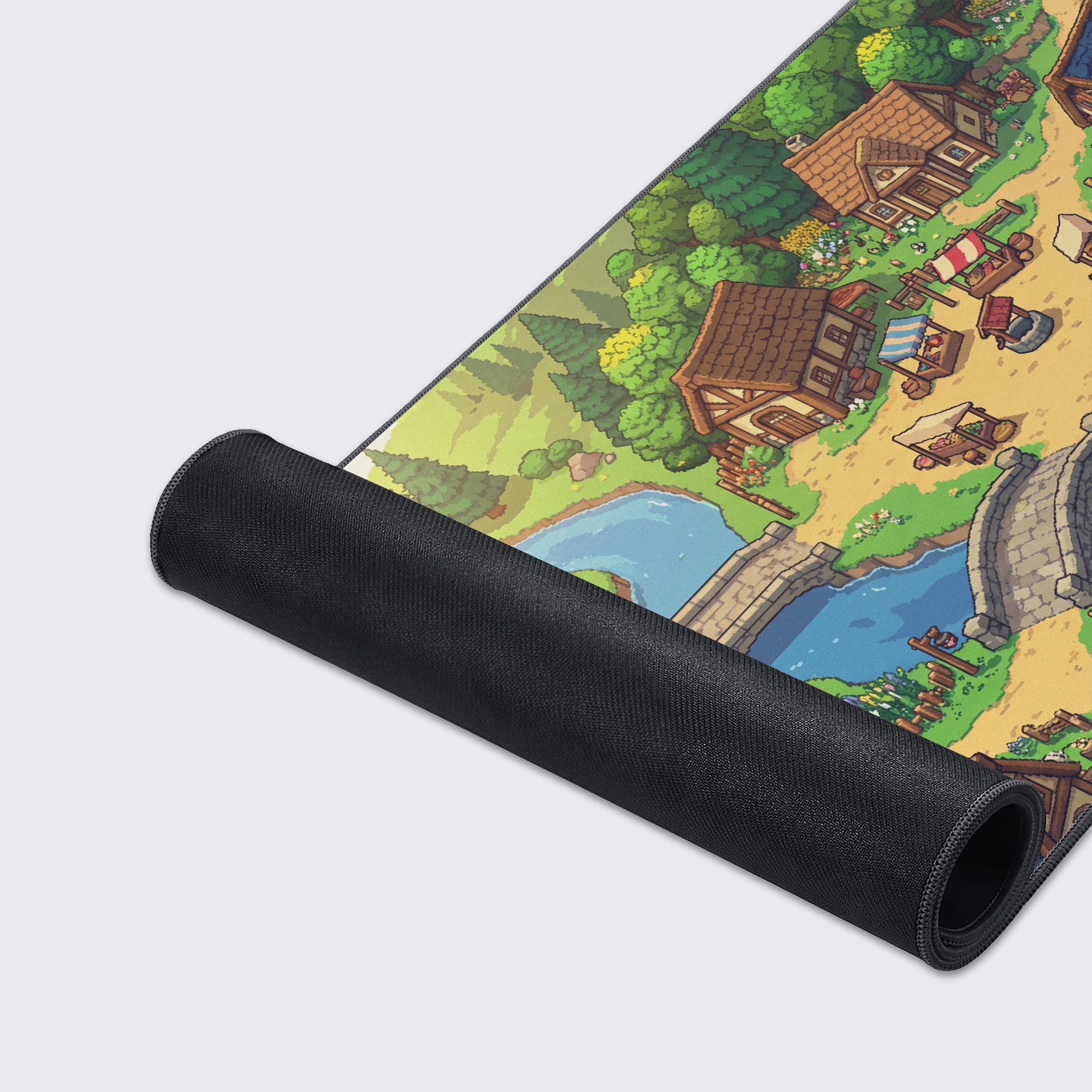 Close-up of the Pixel Valley Gaming Desk Mat's smooth fabric texture and durable stitched edges, highlighting the detailed 8-bit artwork of the fantasy village. - Epic Design Pads & Mousepads