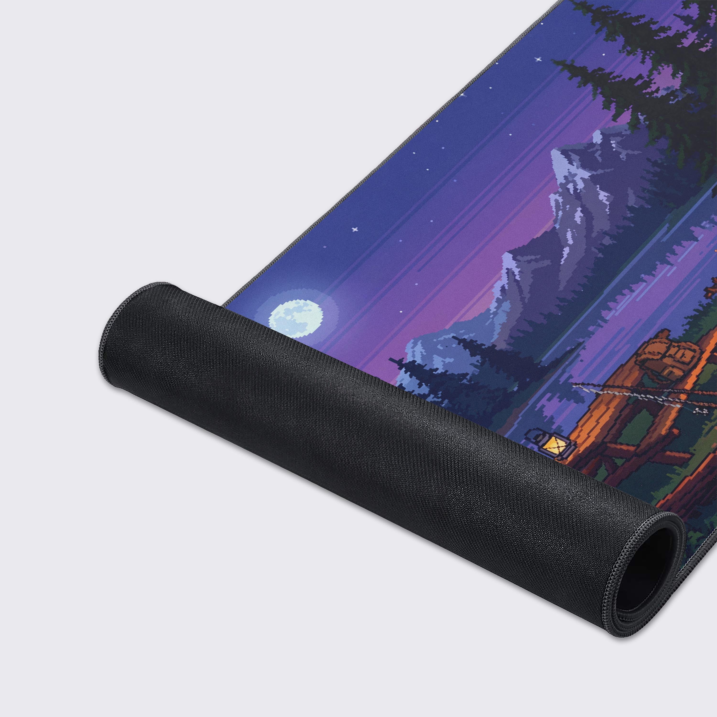 Close-up of the Nightfall Camp gaming desk mat showing the smooth fabric texture and stitched edges, highlighting the vibrant pixel art design of a lakeside campfire. - Epic Design Pads & Mousepads