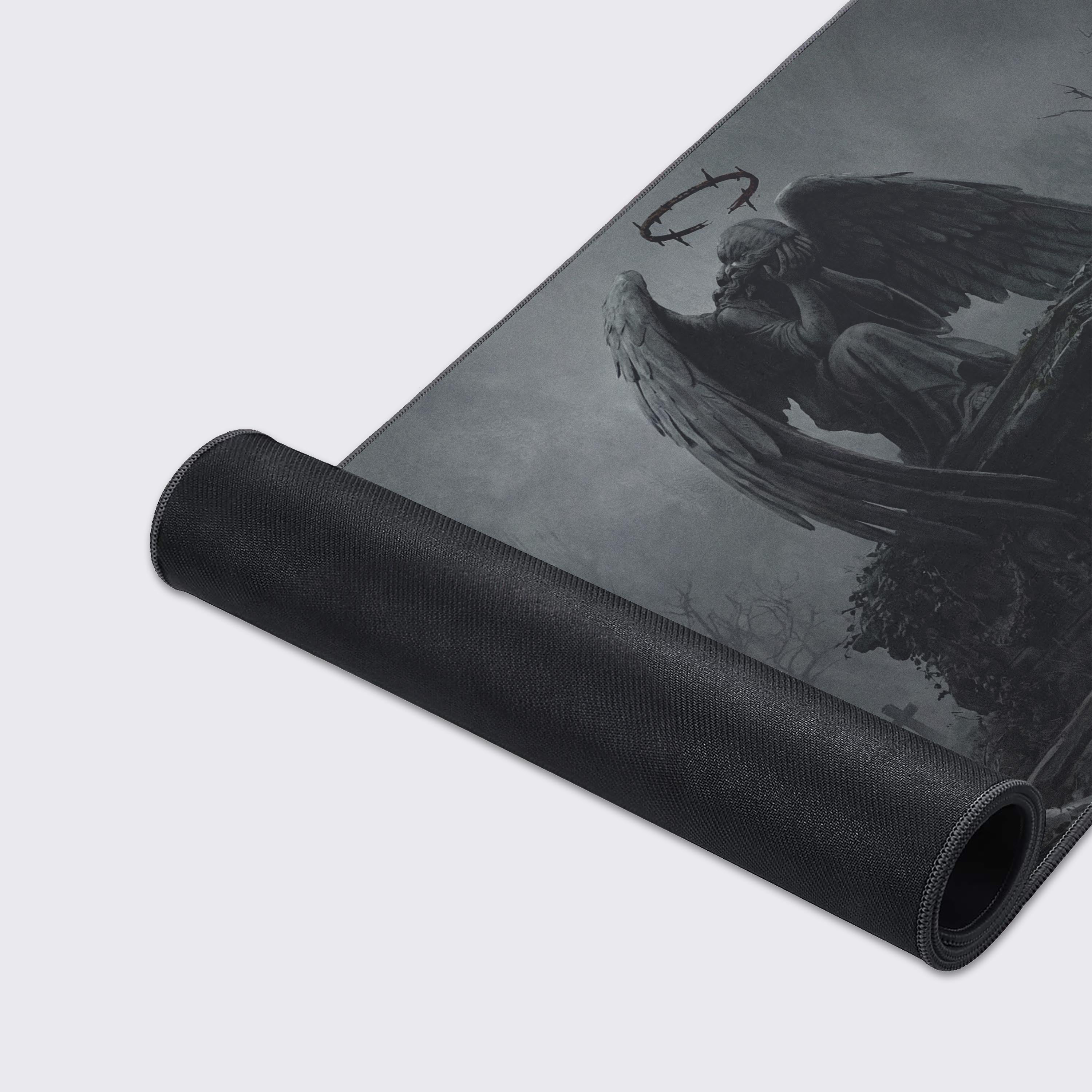 Close-up of the Stone Seraph gaming desk mat highlighting the durable stitched edges and smooth fabric texture of the weeping angel artwork. - Epic Design Pads & Mousepads