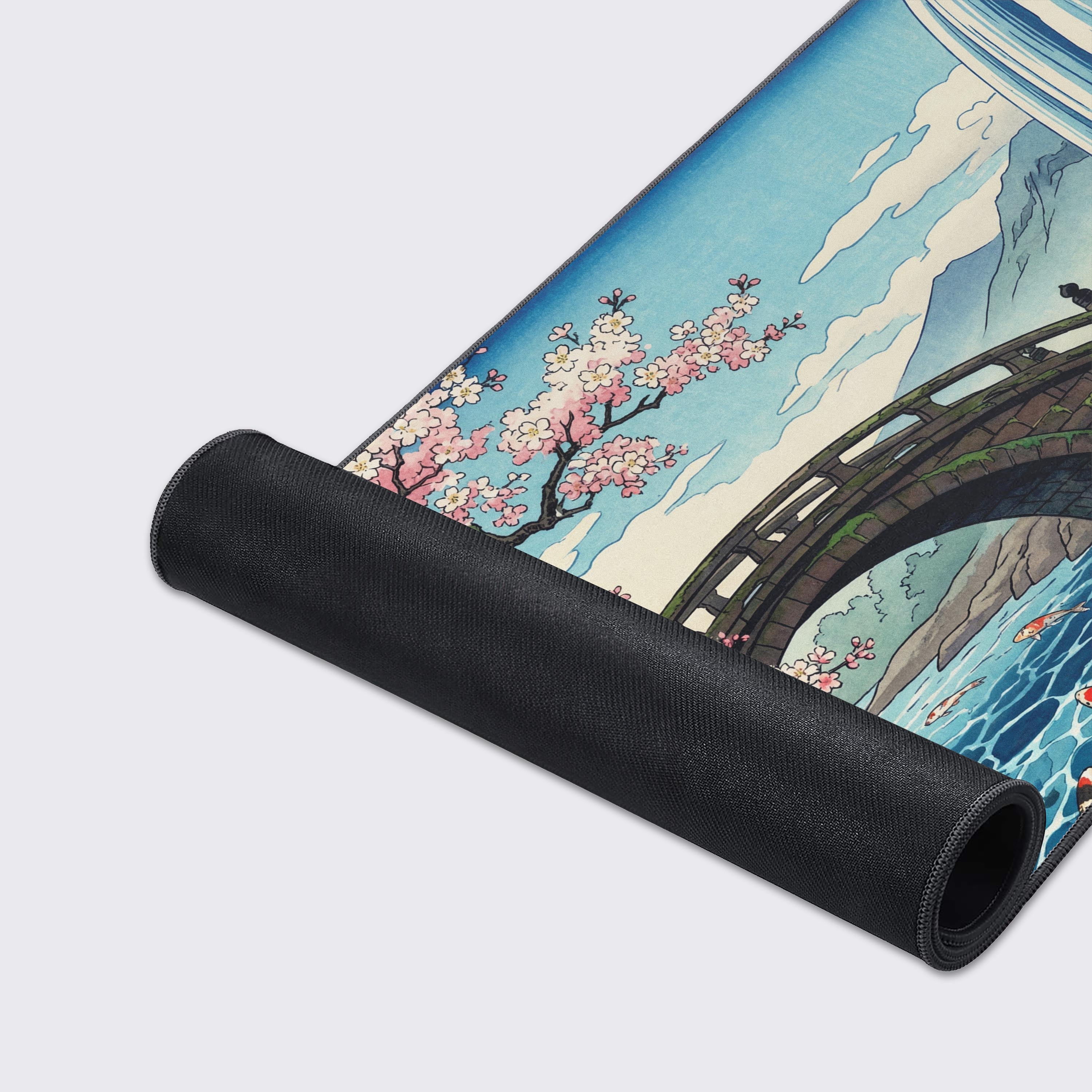 Close-up of the Spring Ukiyo mouse pad's high-quality fabric and stitched edges, showcasing the detailed illustration of koi fish swimming in a vibrant blue river. - Epic Design Pads & Mousepads