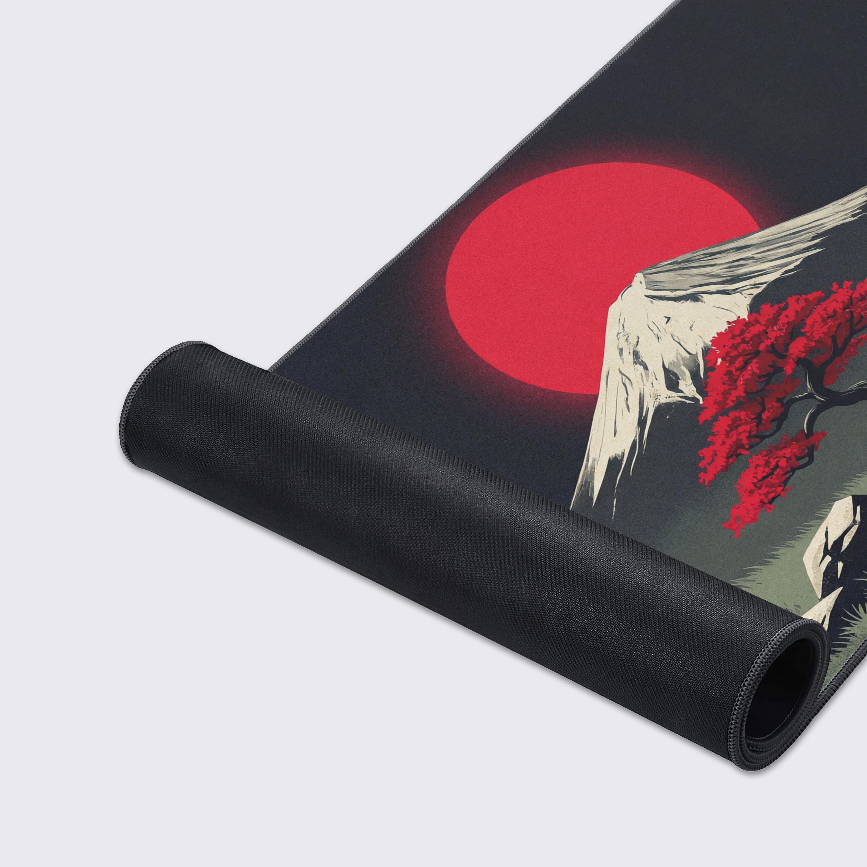 Close-up of the Crimson Zen gaming desk mat's smooth fabric texture and durable stitched edges, highlighting the detailed Mount Fuji and red tree artwork. - Epic Design Pads & Mousepads