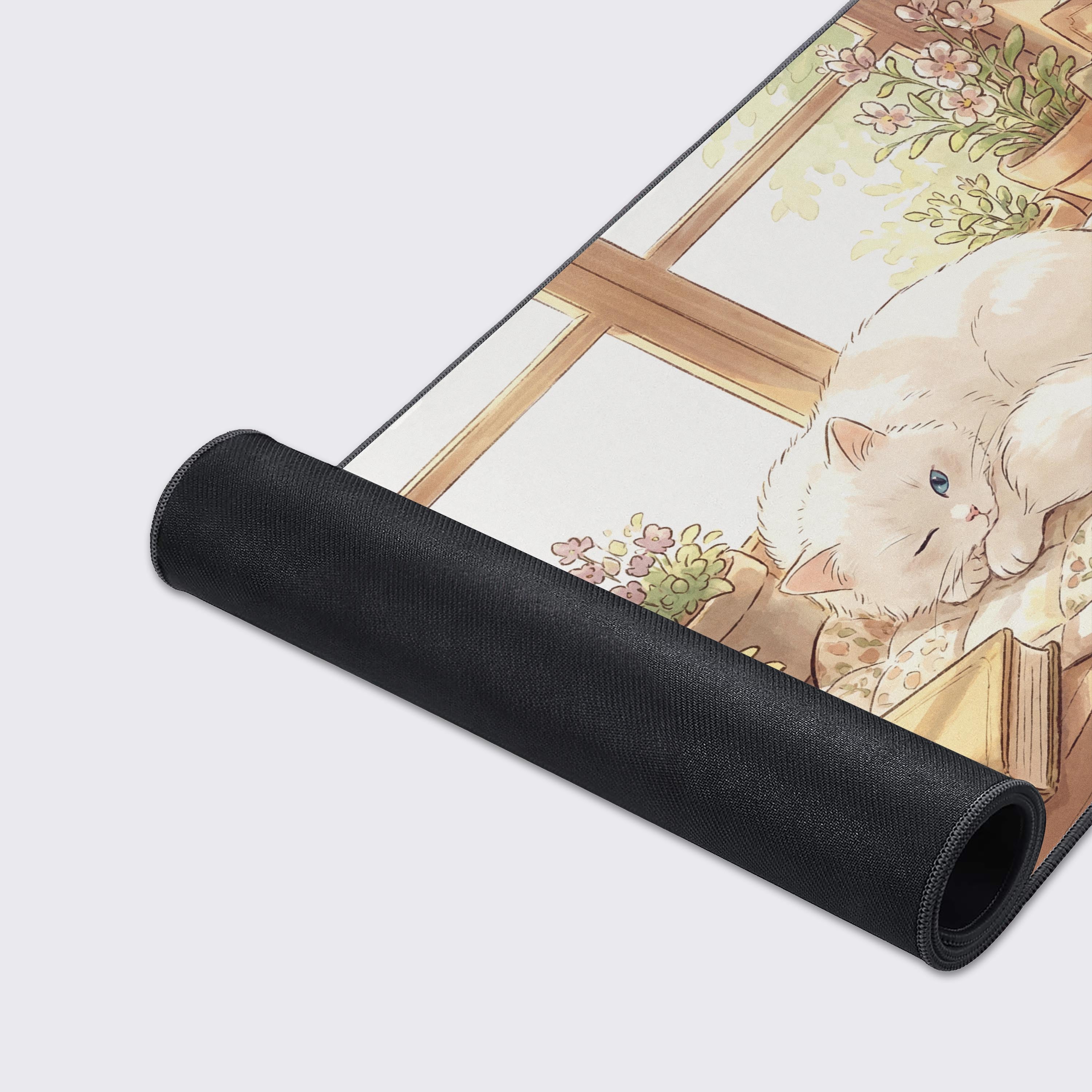 Close-up of the Bookish Nap gaming desk mat highlighting the premium stitched edges and smooth, detailed surface texture of the sleeping white cat artwork. - Epic Design Pads & Mousepads