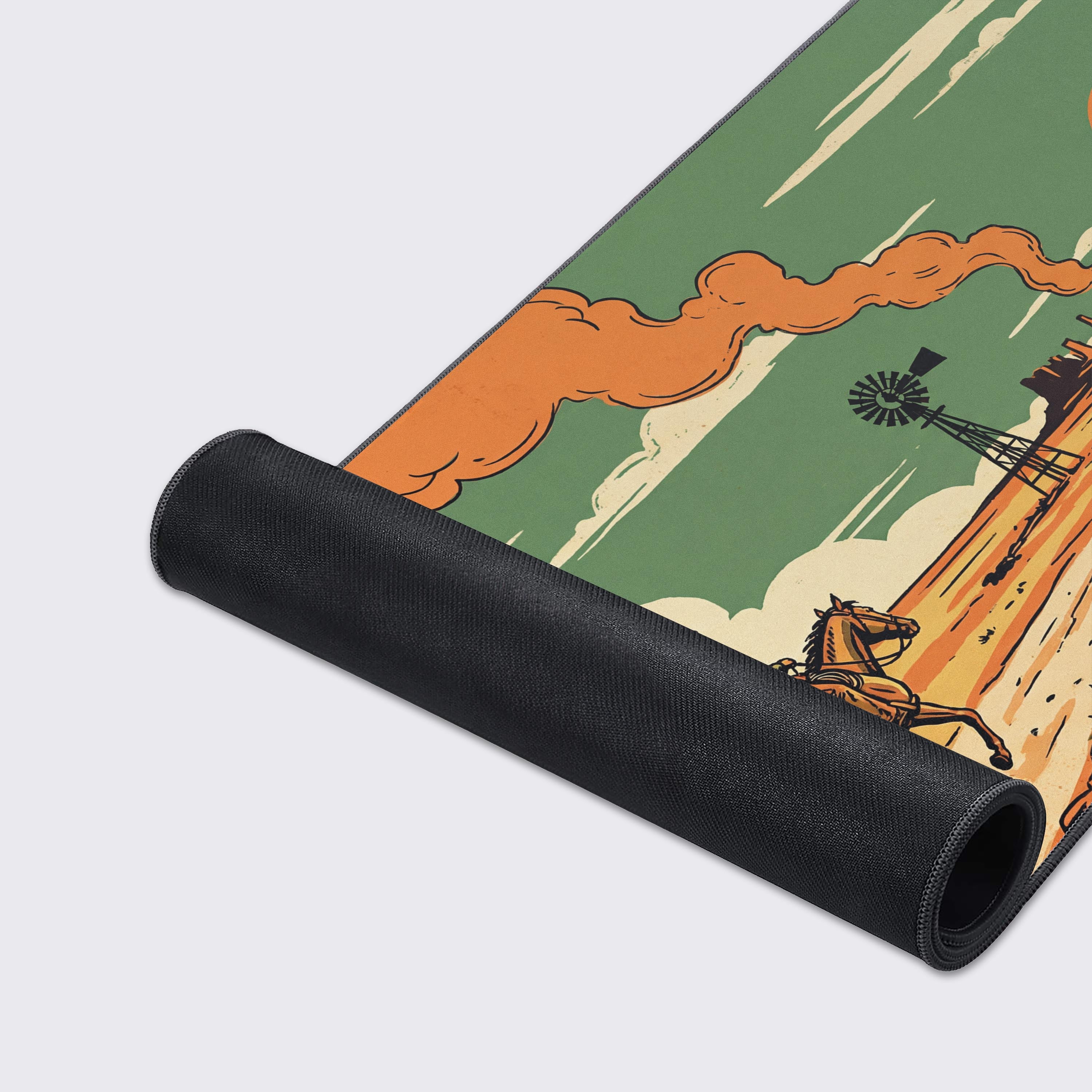 A close-up of the Dust & Glory Gaming Desk Mat highlights the quality stitched edges and smooth texture of the vintage cowboy and desert artwork. - Epic Design Pads & Mousepads