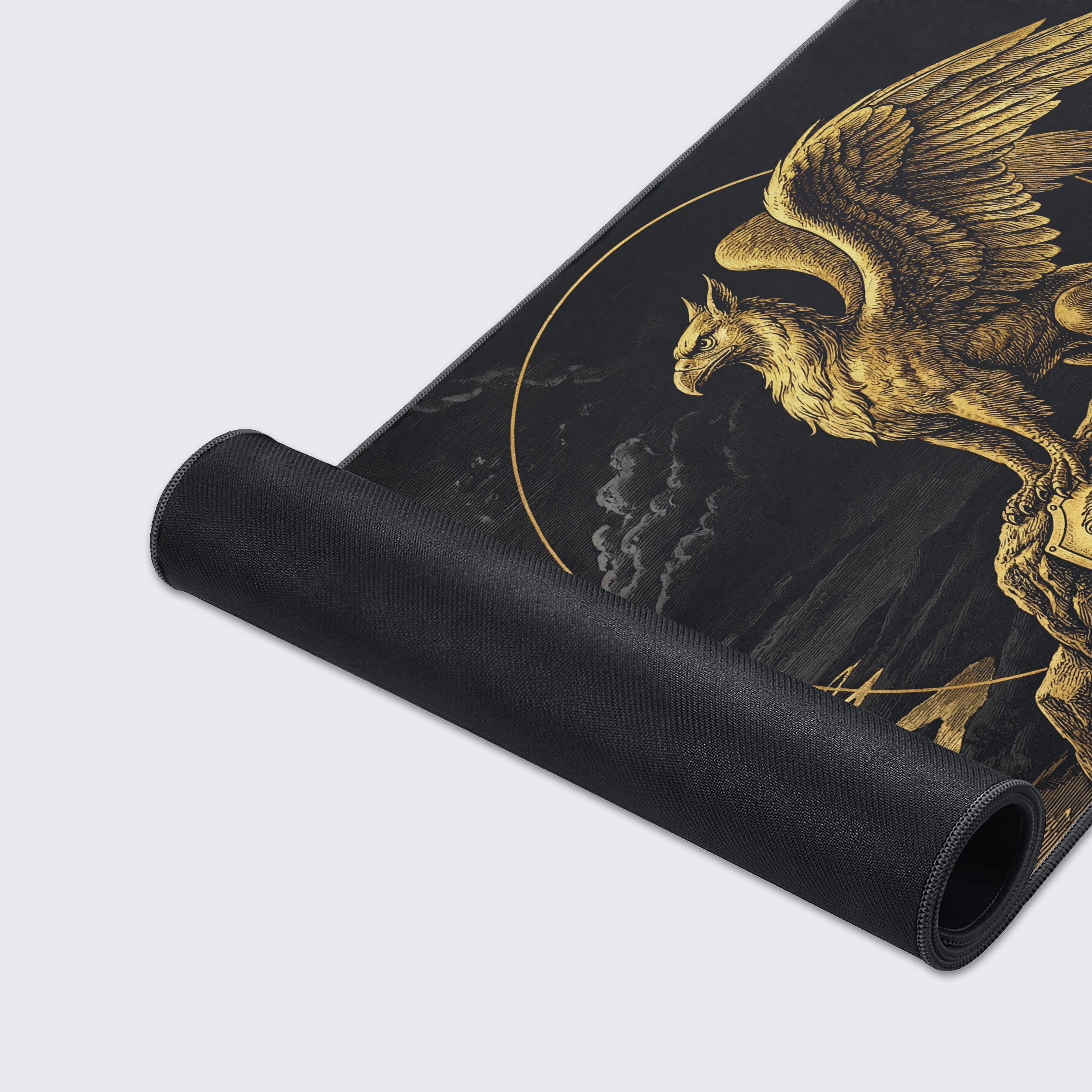 A close-up of the Gilded Gryphon gaming desk mat, highlighting the high-quality fabric texture, durable stitched edges, and the intricate gold line work of the fantasy design. - Epic Design Pads & Mousepads