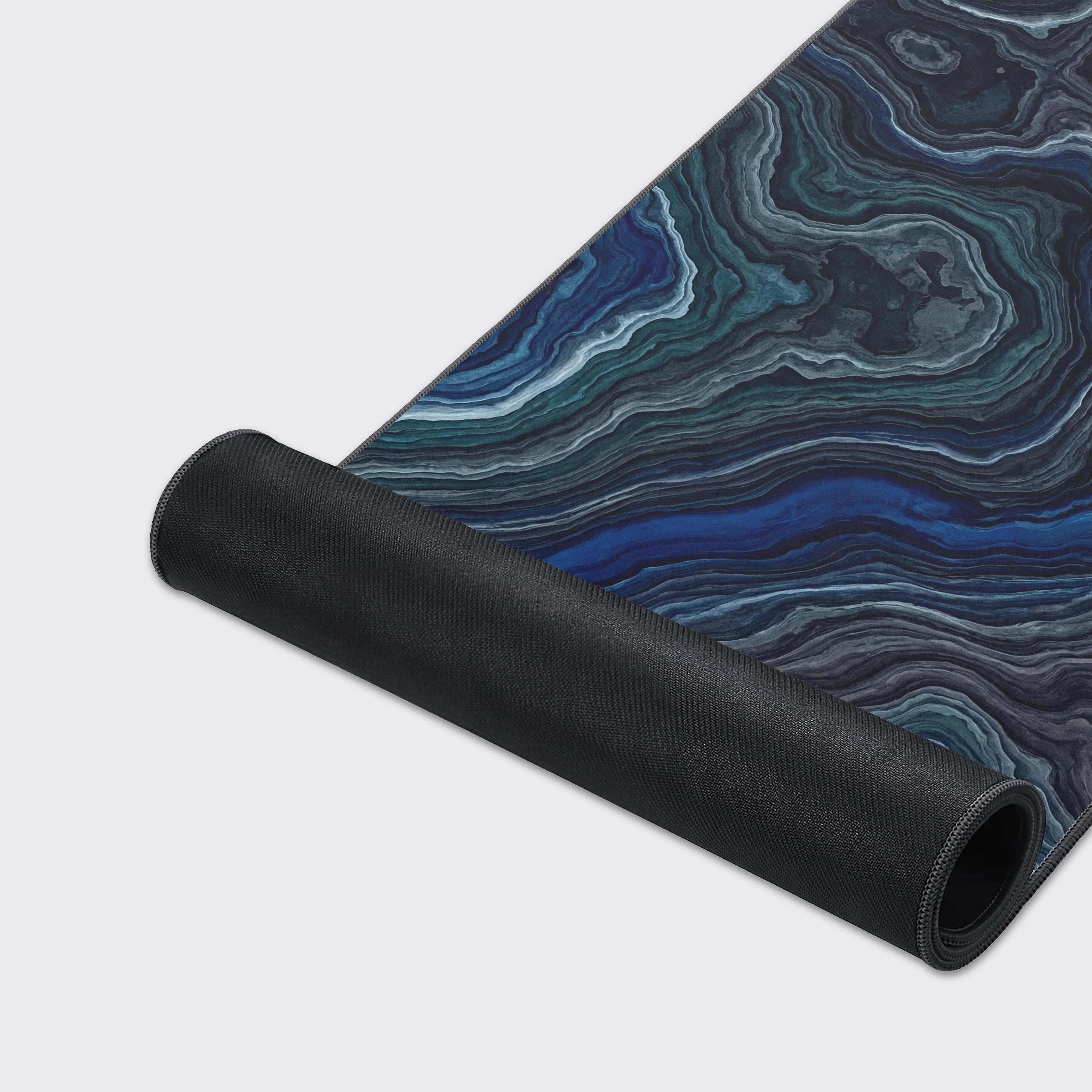 Close-up of the Deep Strata gaming desk mat showcasing the smooth texture and intricate blue geode pattern, with durable stitched edges for longevity. - Epic Design Pads & Mousepads