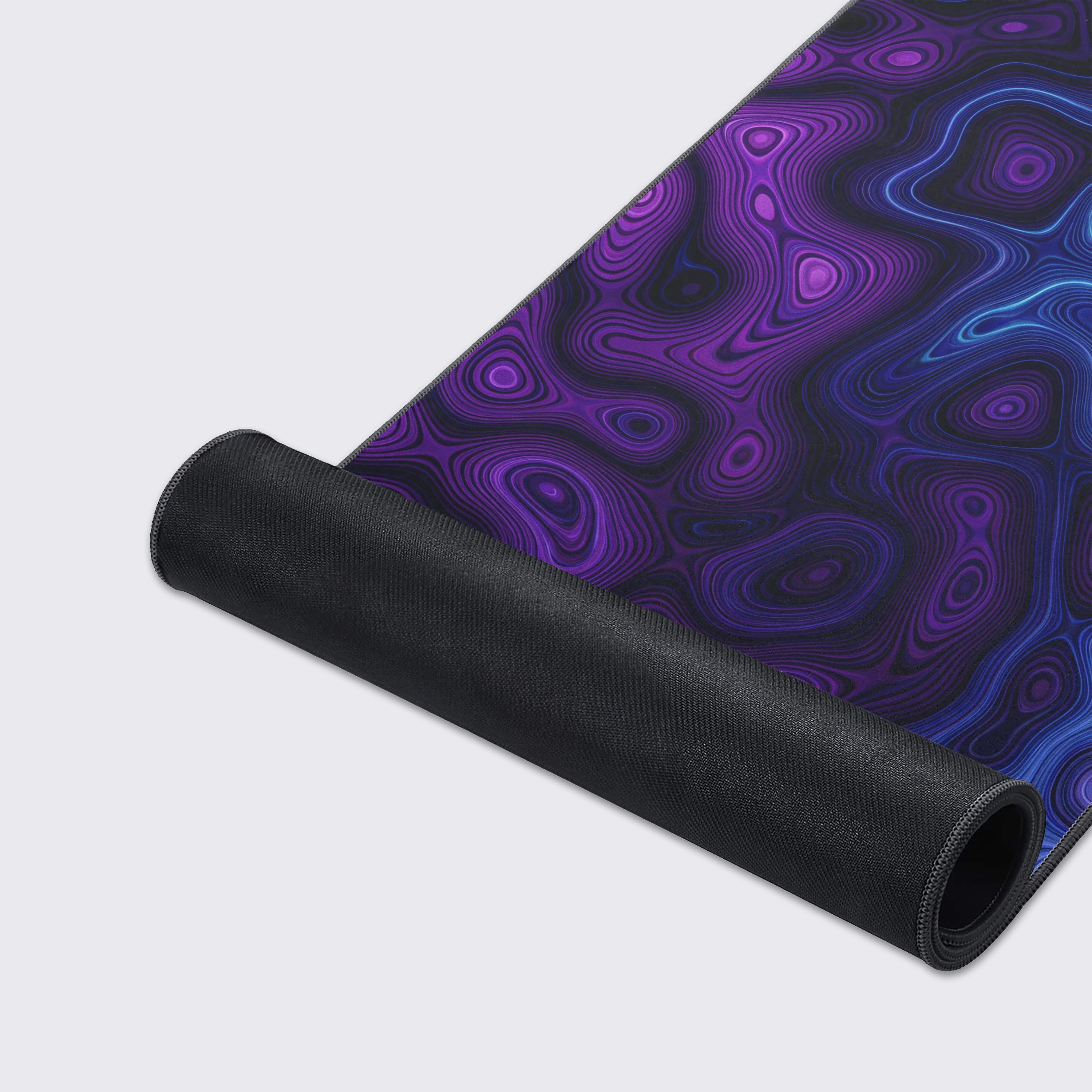A close-up of the Neon Damascus mouse pad's high-quality fabric texture and durable stitched edges, highlighting the intricate, glowing blue and purple line work. - Epic Design Pads & Mousepads