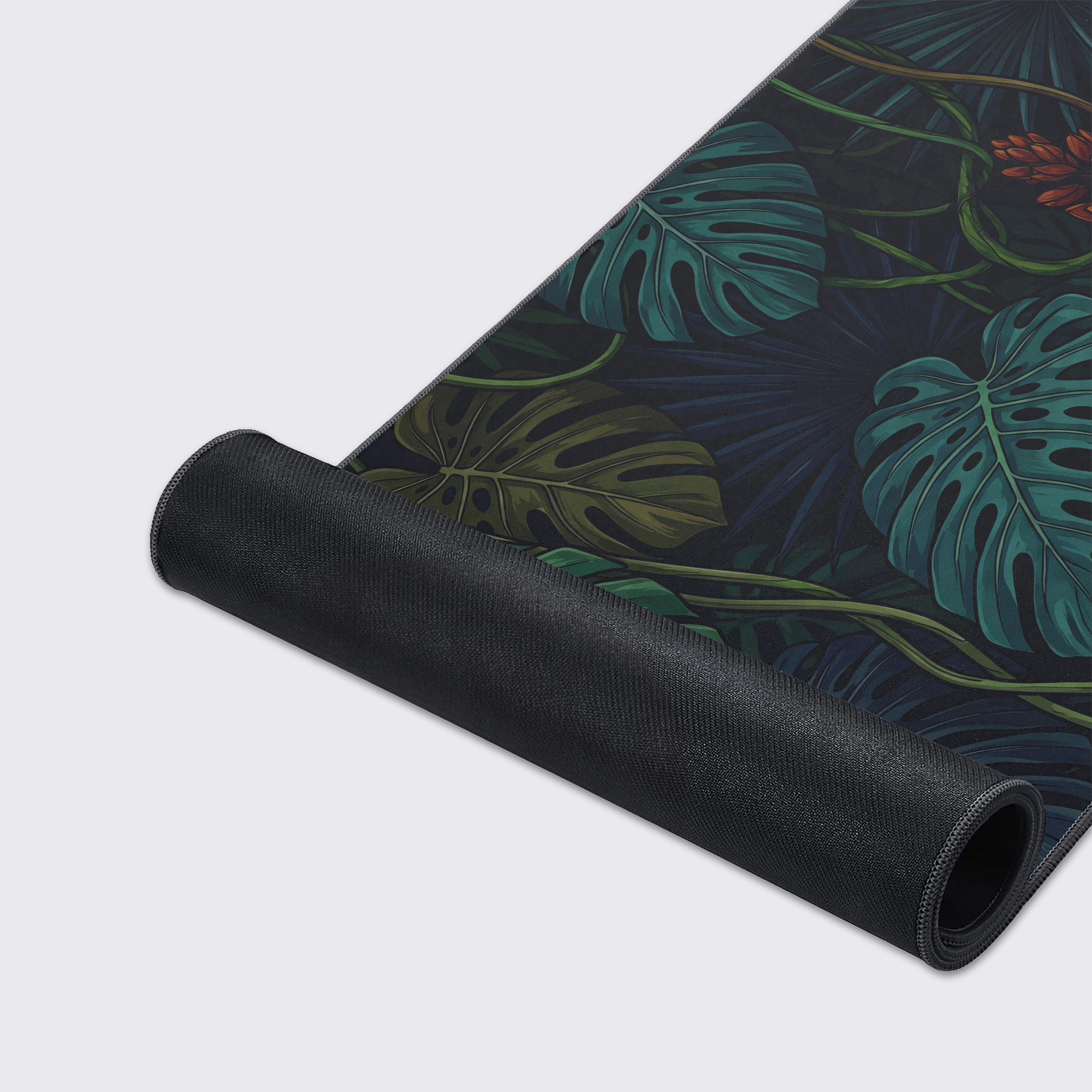 Close-up of the Midnight Jungle gaming desk mat, highlighting the detailed plant illustration and durable stitched edges on the smooth, non-slip fabric. - Epic Design Pads & Mousepads