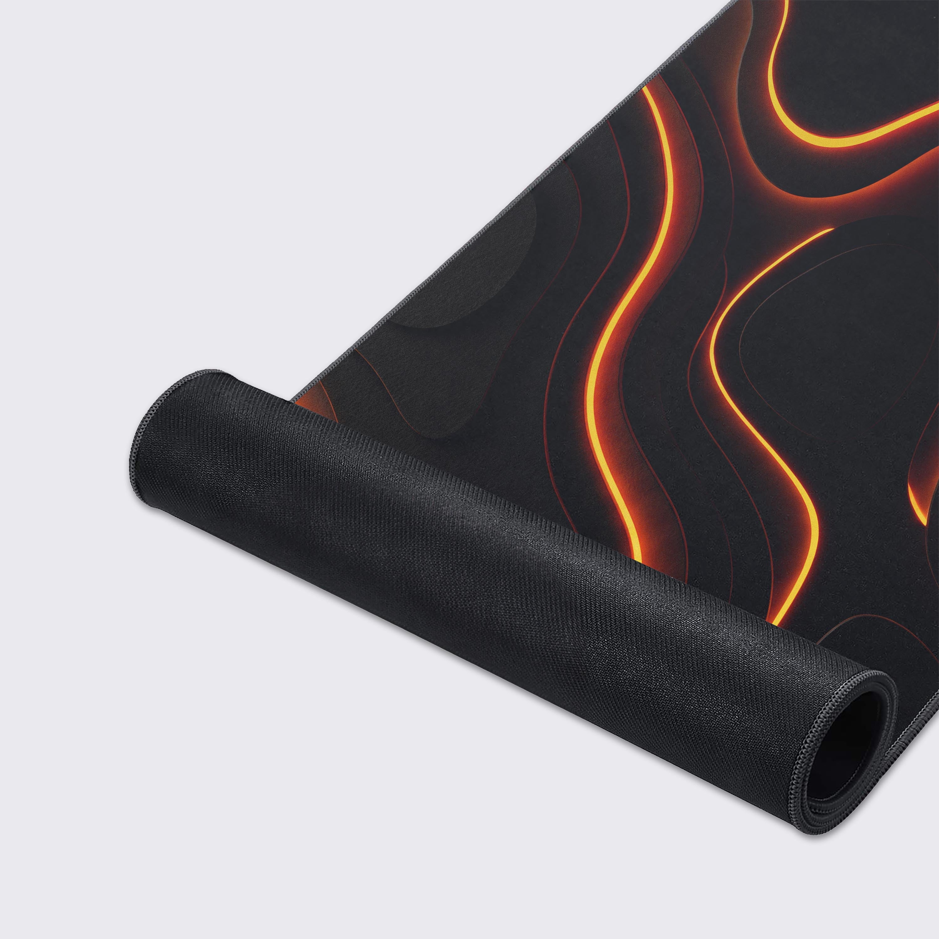 A close-up of the Tectonic Shift gaming desk mat, highlighting its smooth fabric texture and durable stitched edges on the abstract molten rock design. - Epic Design Pads & Mousepads