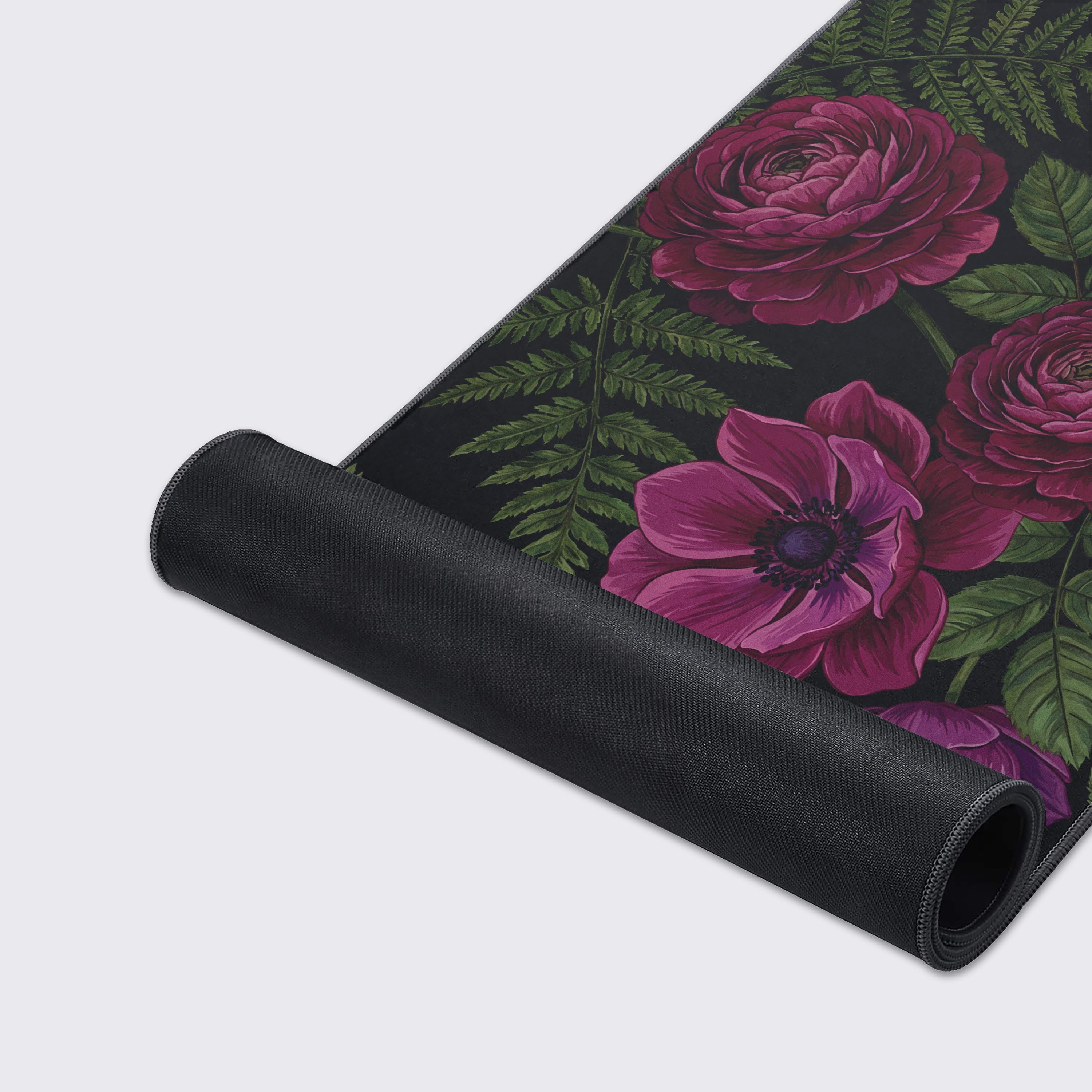 Close-up of the Velvet Fern mouse pad's smooth texture and durable stitched edges, highlighting the intricate purple anemone and green fern illustration on a black background. - Epic Design Pads & Mousepads