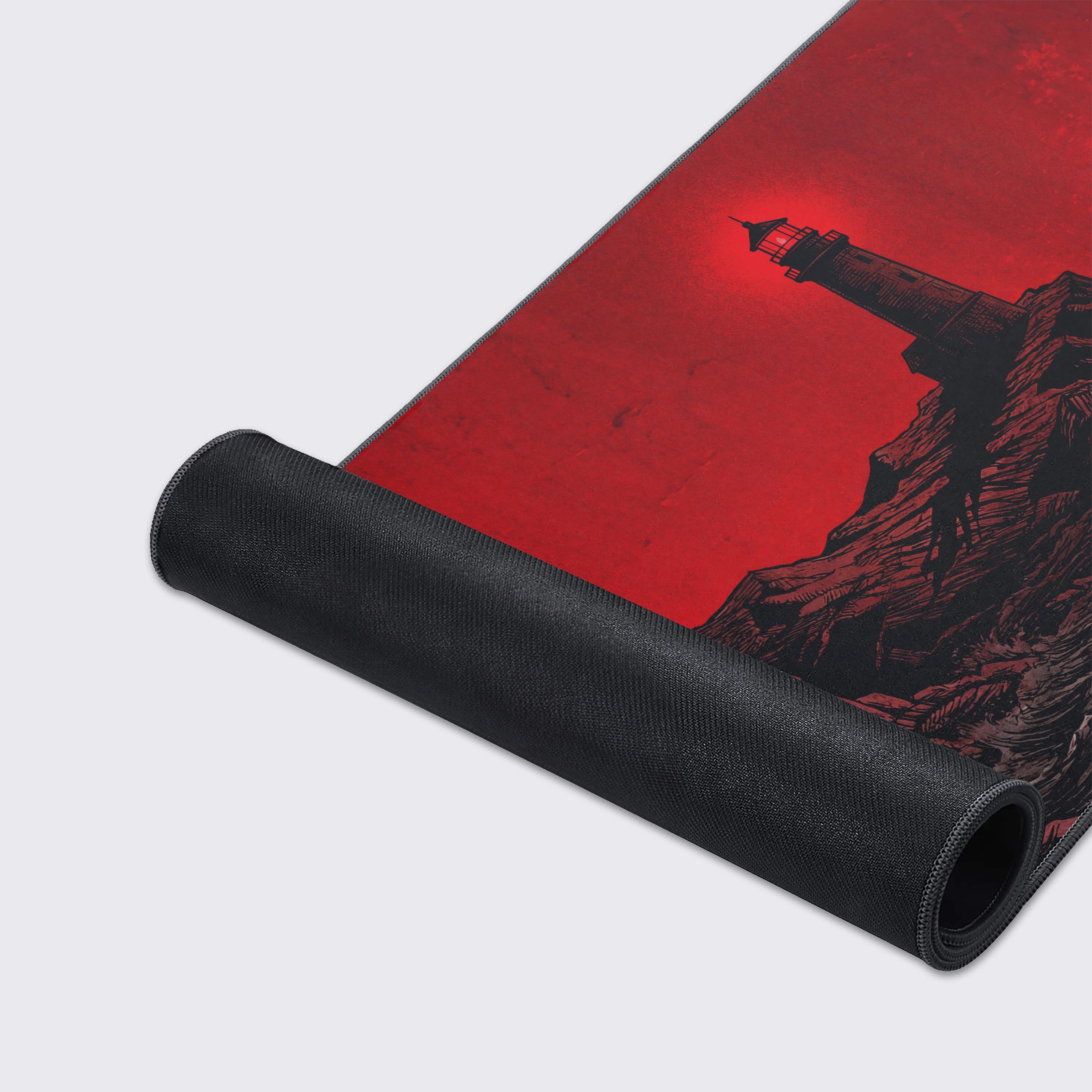 A close-up of The Night Watch gaming desk mat, highlighting the durable stitched edges and the detailed vintage engraving texture of the lighthouse. - Epic Design Pads & Mousepads