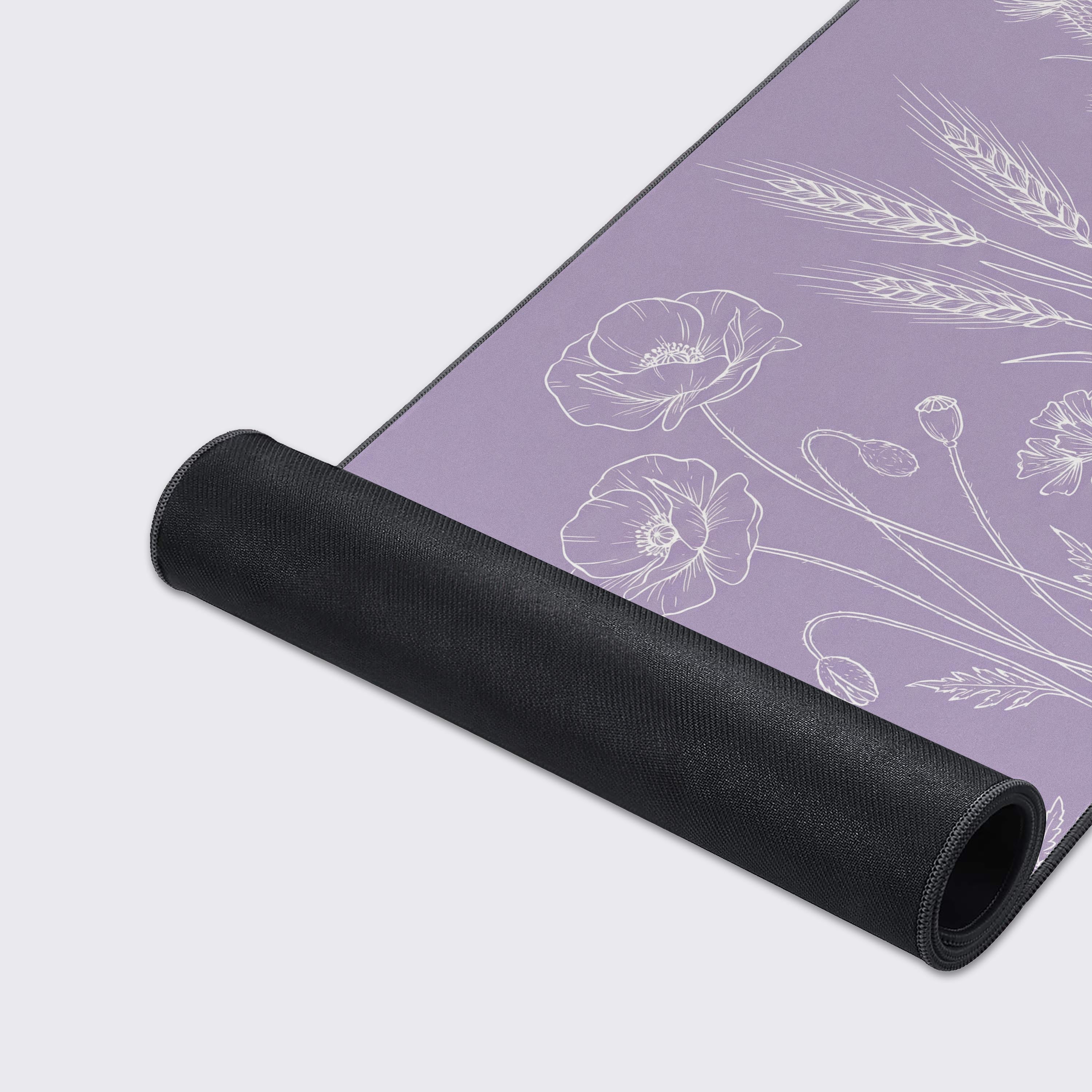 A close-up of the Lavender Botanica mouse pad's smooth texture and durable stitched edges, highlighting the delicate white wildflower line art on the lavender surface. - Epic Design Pads & Mousepads