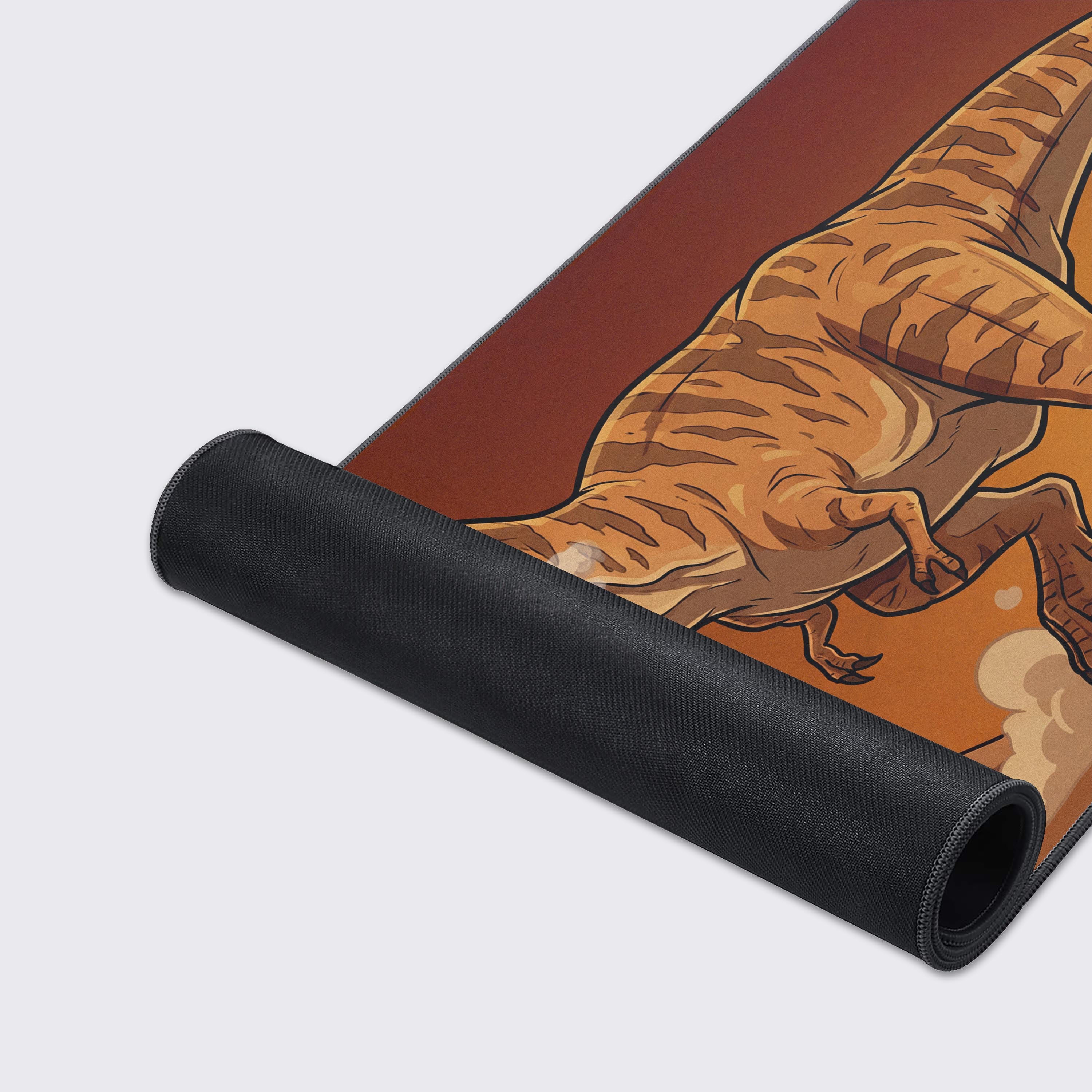 A close-up of the Desert Tyrant gaming desk mat, highlighting the durable stitched edges and smooth fabric texture of the roaring dinosaur artwork. - Epic Design Pads & Mousepads