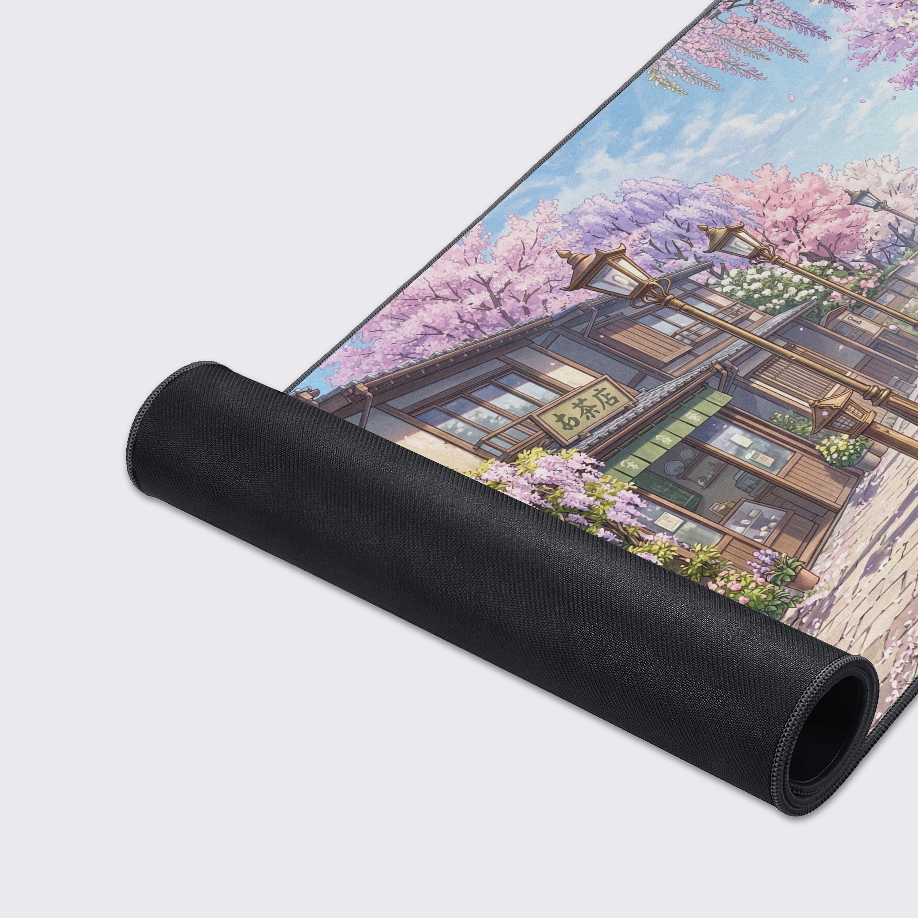 A close-up of the Springtime Stroll gaming desk mat, highlighting the smooth fabric texture, durable stitched edges, and the vibrant, detailed anime artwork of a bookstore. - Epic Design Pads & Mousepads