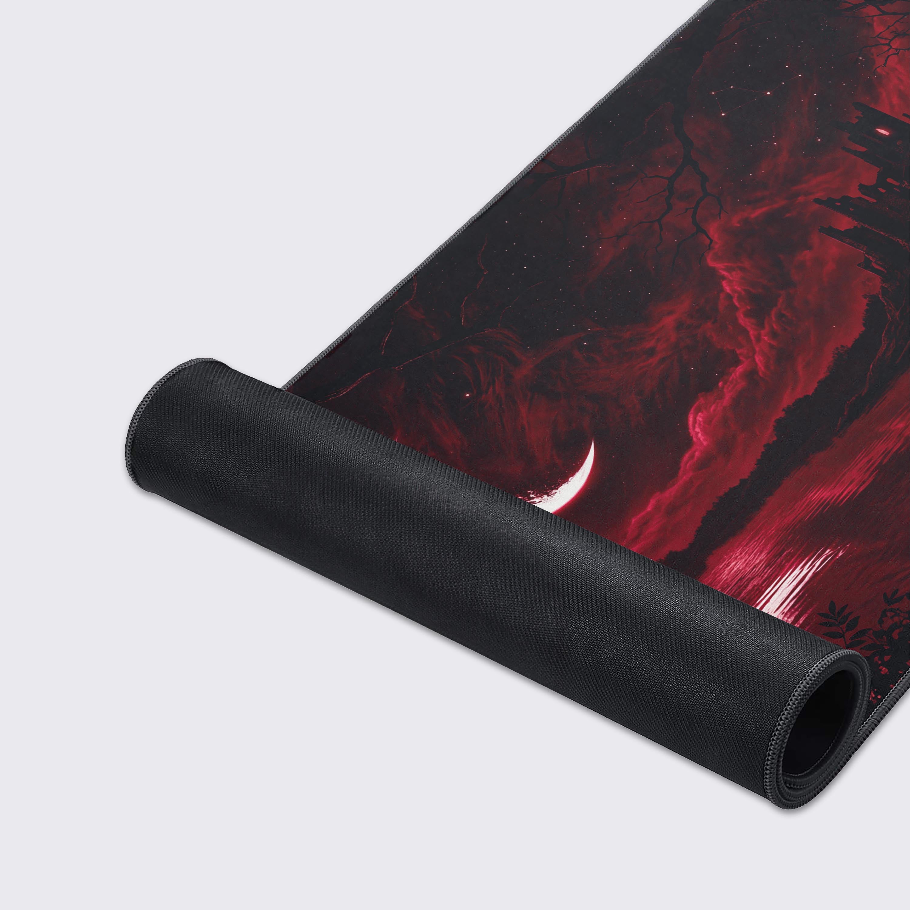 A close-up of the Blood Moon Keep gaming desk mat, highlighting the high-quality fabric texture, stitched edges, and the detailed crimson castle artwork. - Epic Design Pads & Mousepads