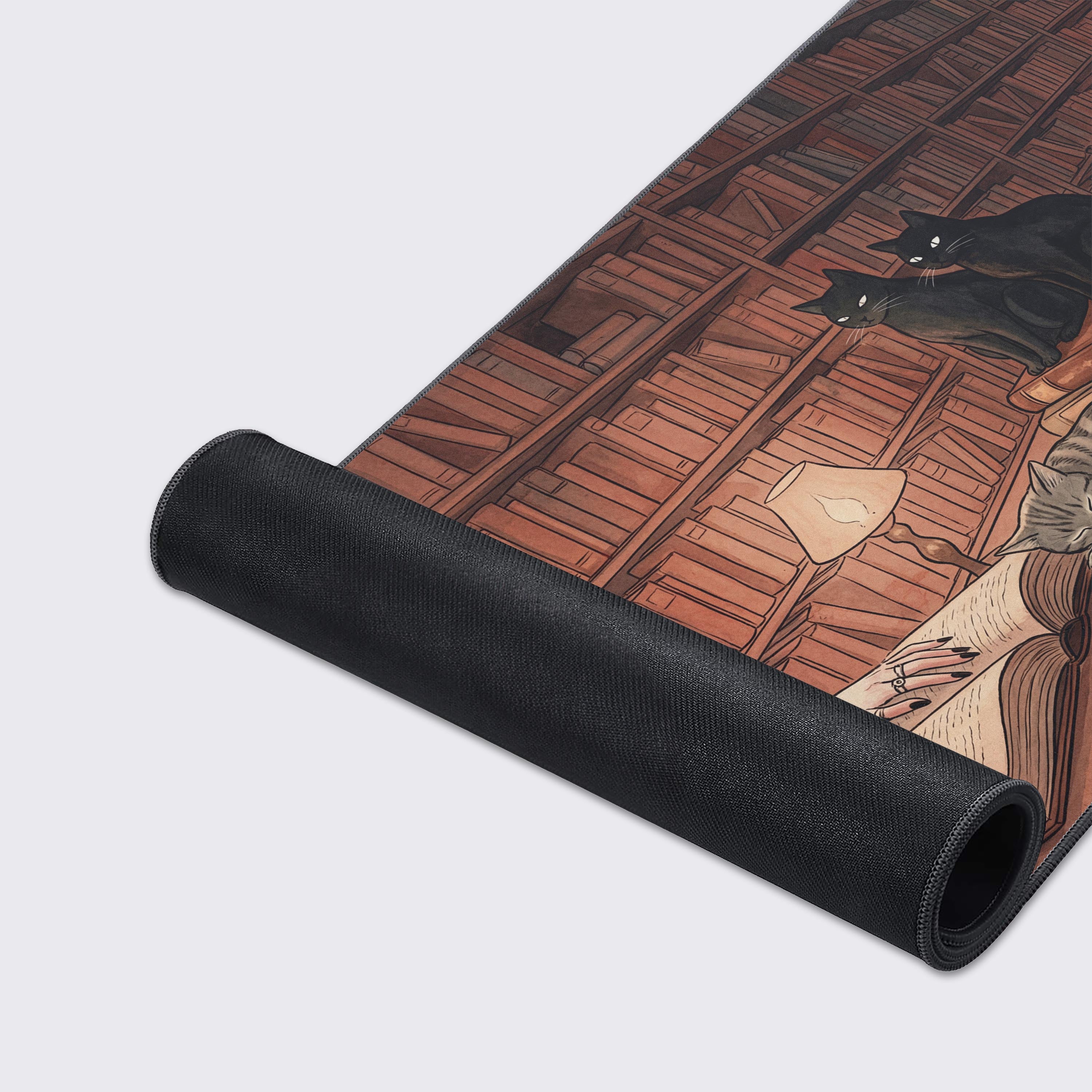 A close-up of the Midnight Library mouse pad's smooth fabric texture and durable stitched edges, showing the detailed artwork of the scene. - Epic Design Pads & Mousepads