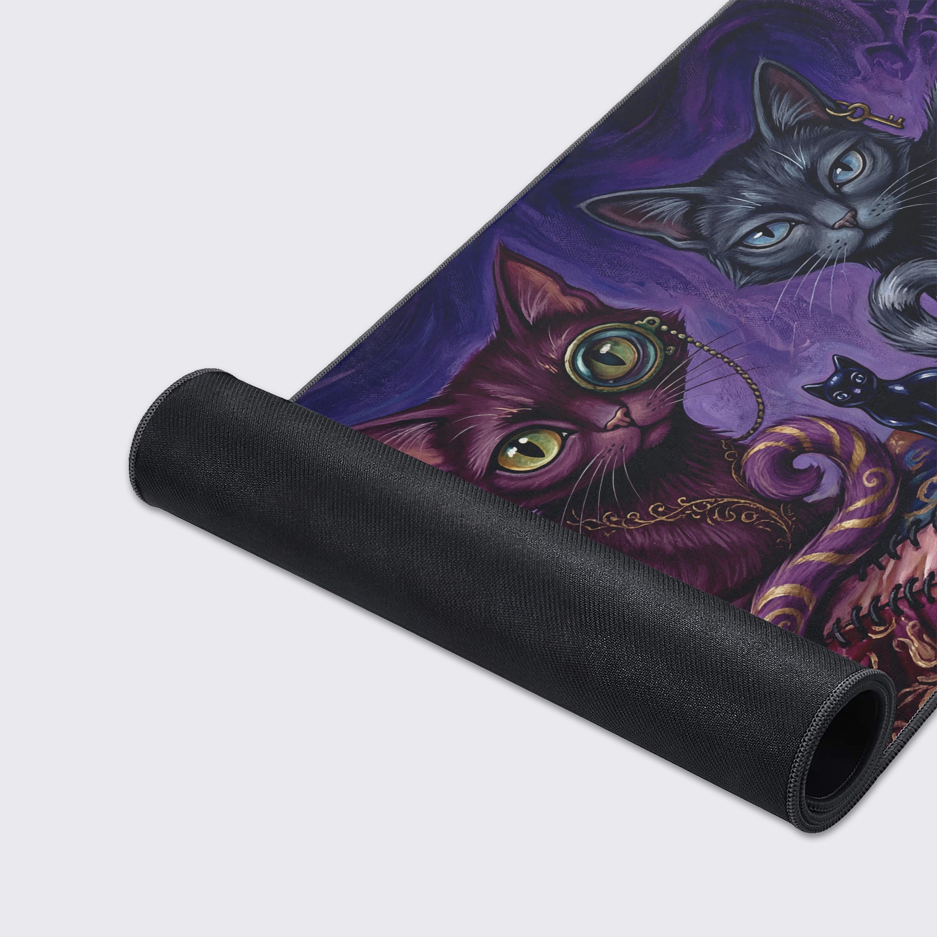 A close-up of the Stitched Shadows gaming desk mat, highlighting the detailed artwork of the purple cat with a monocle and the durable, anti-fray stitched edges. - Epic Design Pads & Mousepads