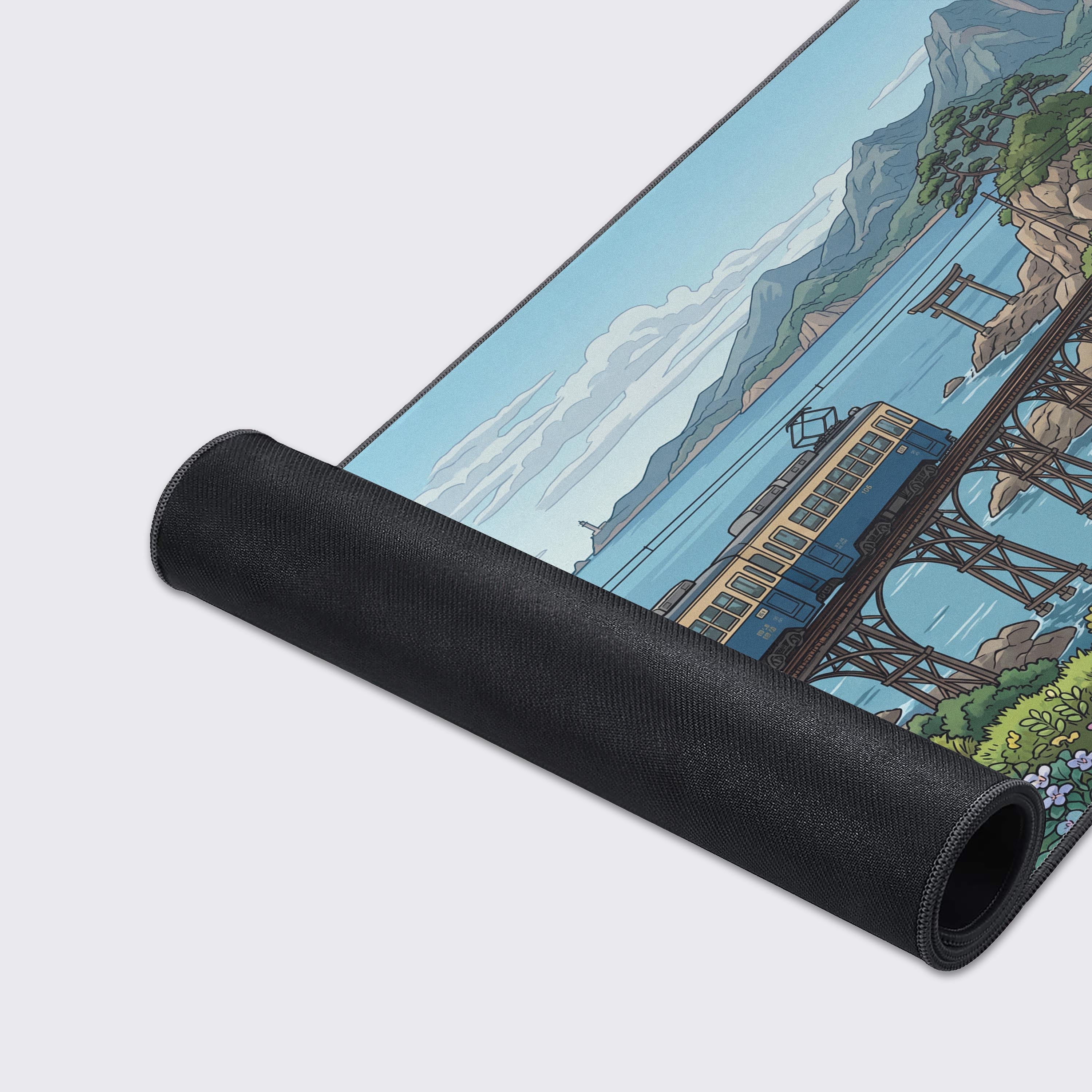 A close-up of the Coastal Transit mouse pad, highlighting the high-quality fabric texture and durable stitched edges of the Japanese train and sea illustration. - Epic Design Pads & Mousepads