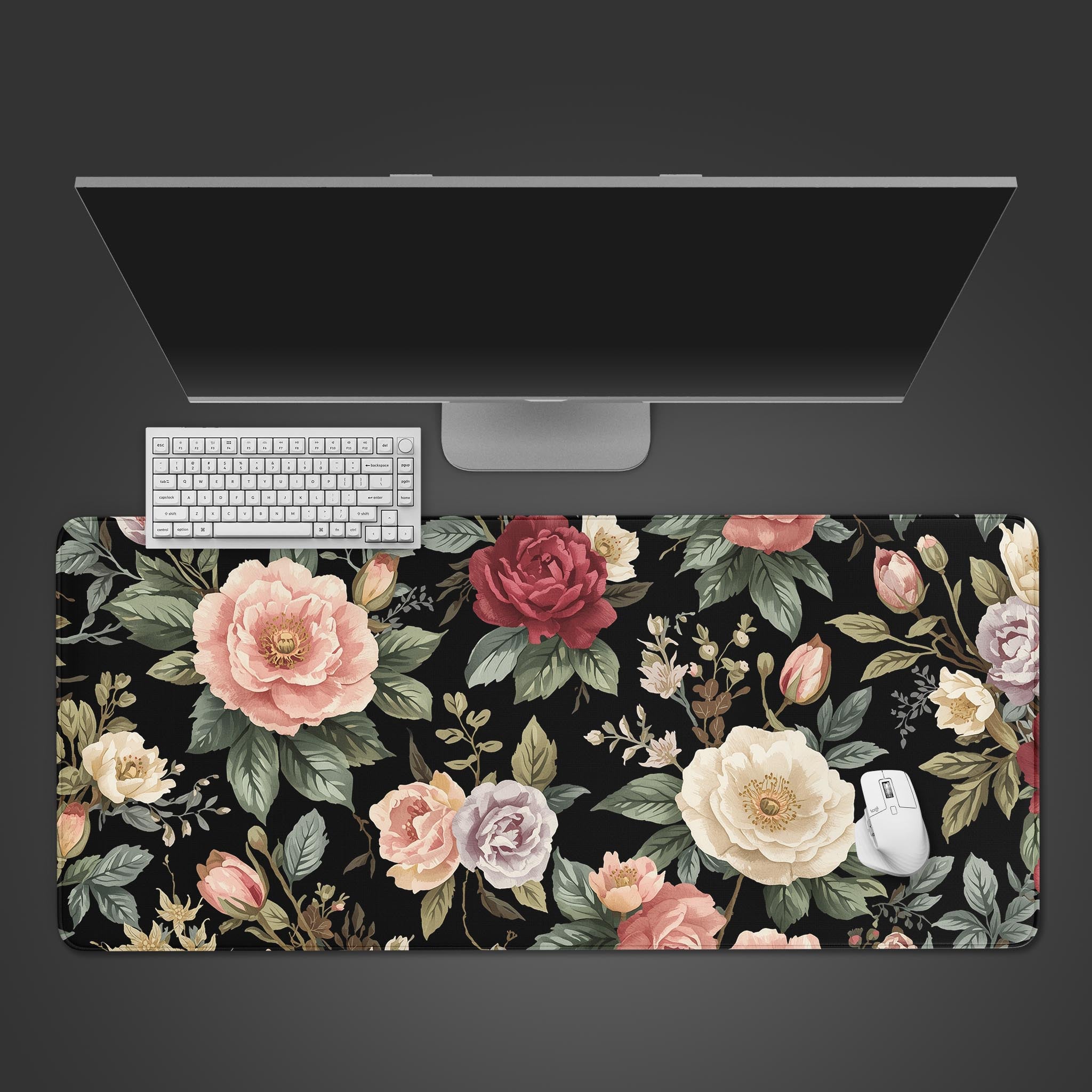 Floral desk mat with a computer setup on a black background