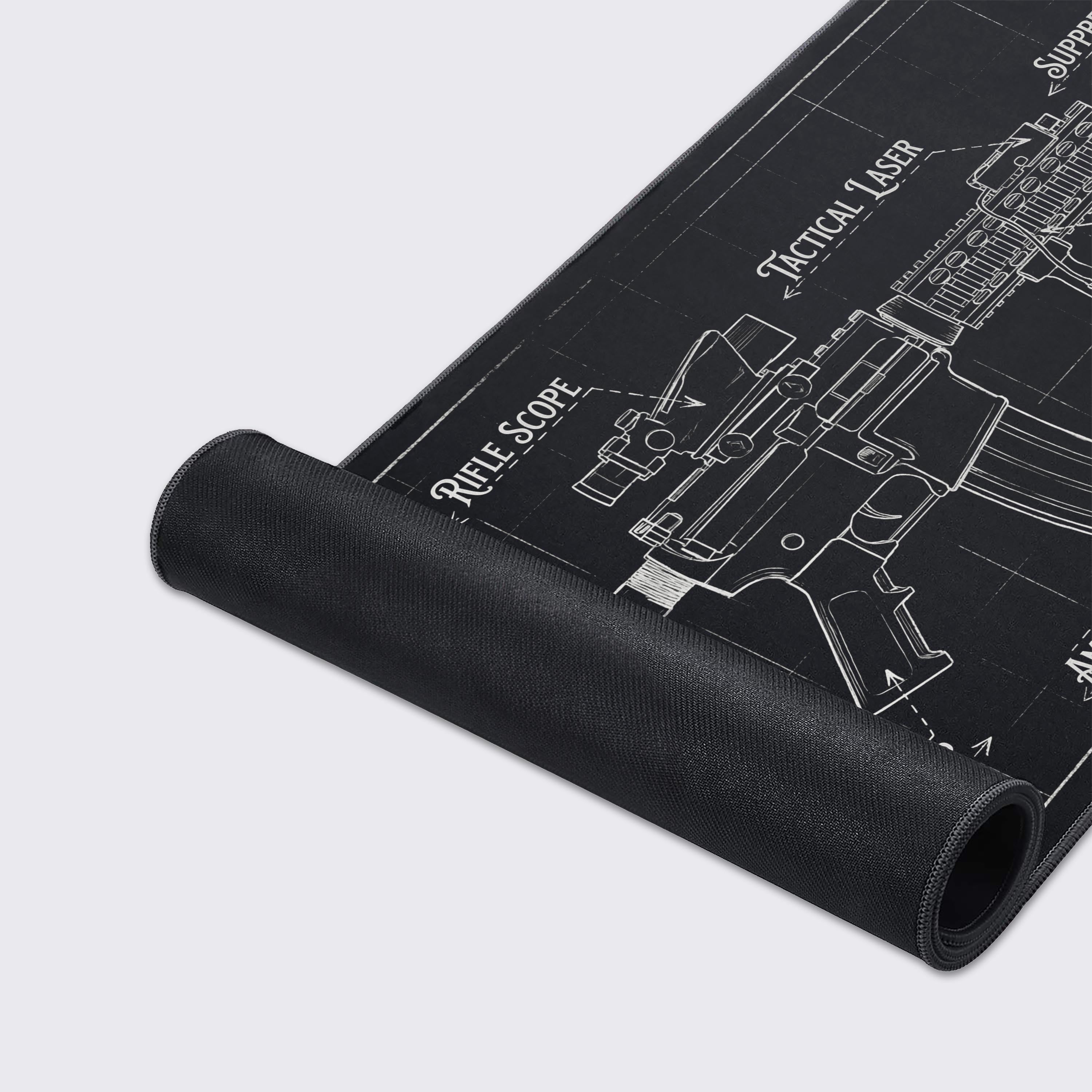 A close-up of the Tactical Blueprint Gaming Desk Mat, highlighting the high-quality stitched edges and the smooth fabric texture of the rifle schematic design. - Epic Design Pads & Mousepads