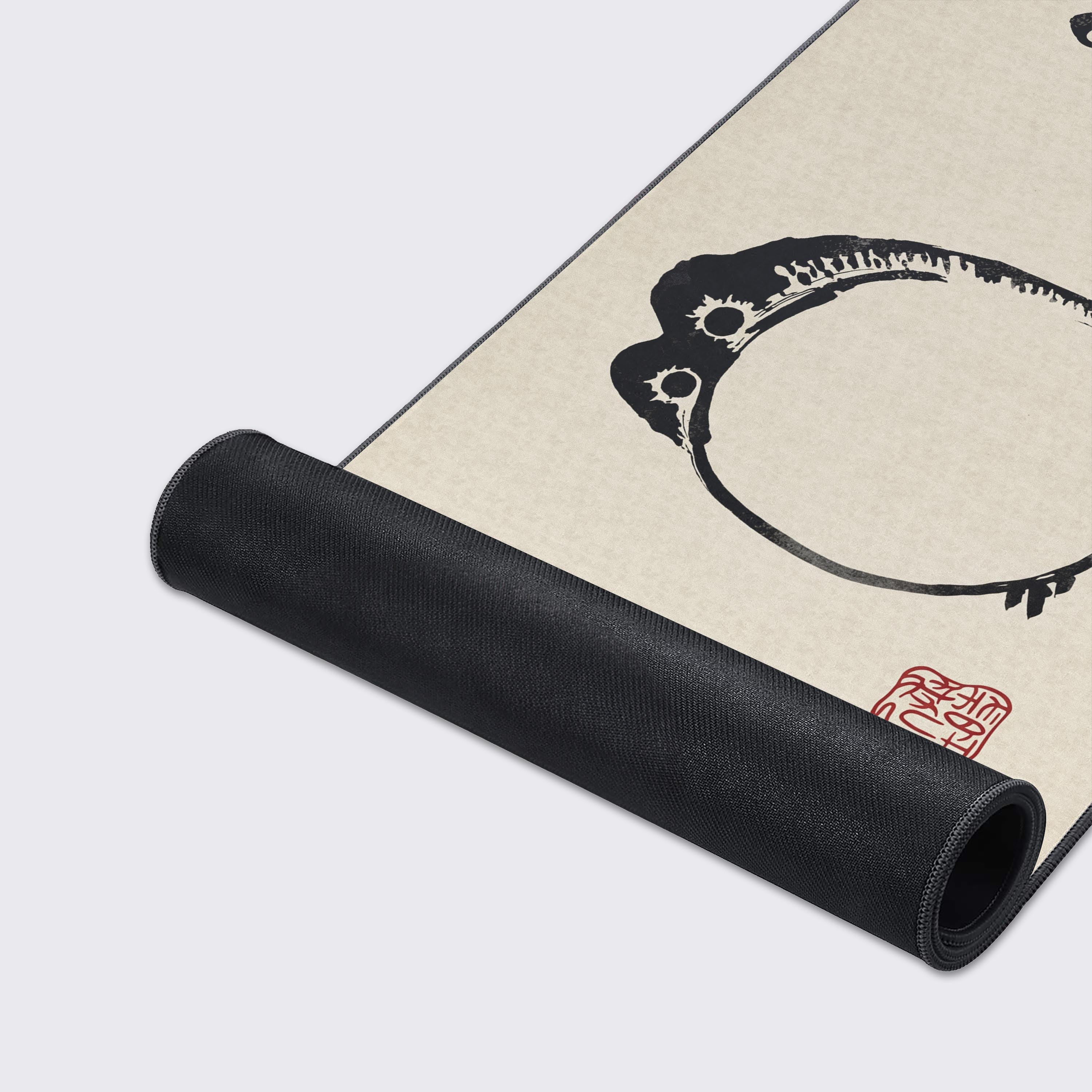 Close-up of the Grumpy Frog desk mat, highlighting the high-quality print, stitched edges, and non-slip rubber base for stability. - Epic Design Pads & Mousepads