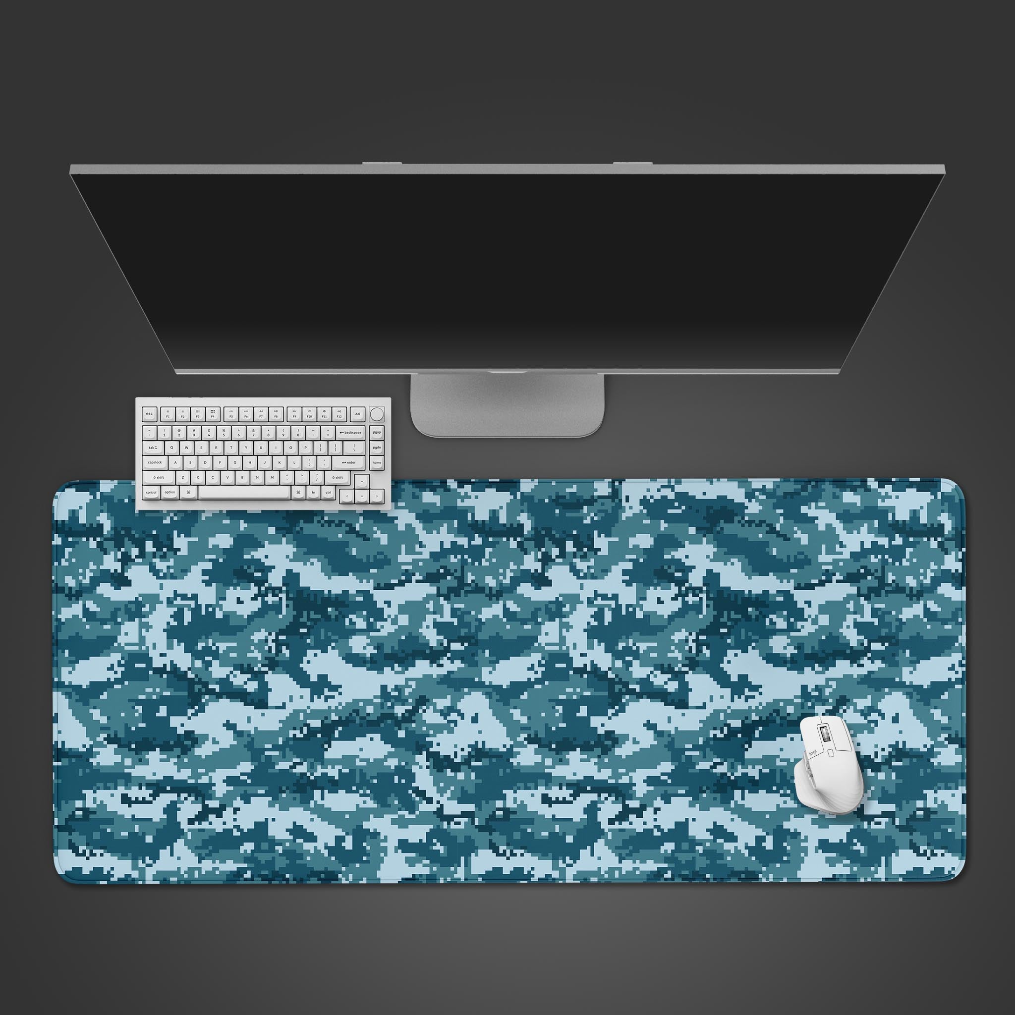 Aqua Pixel Camo gaming desk mat in shades of blue and teal, shown from a top-down desktop view with a black keyboard and mouse. - Epic Design Pads