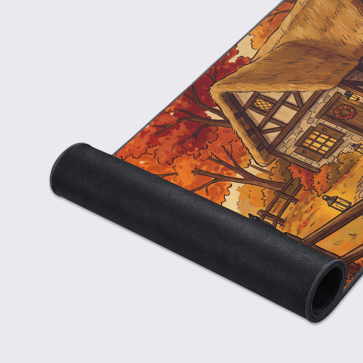 Detail of the cozy cottage desk pad art featuring a bubbling green cauldron, scattered orange pumpkins, and a rustic stone chimney.