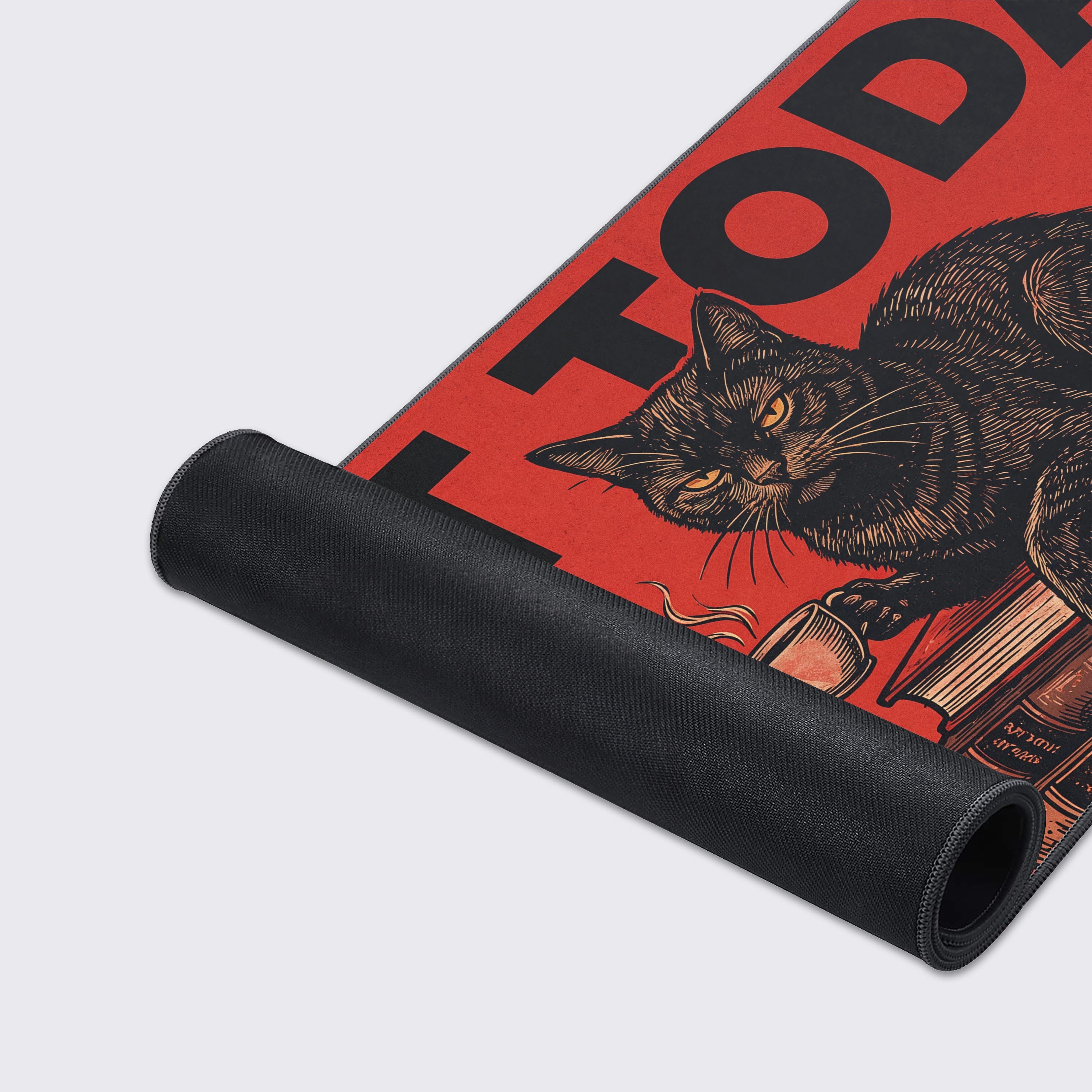 Detailed view showing the vibrant red and black colors of the humorous cat desk pad