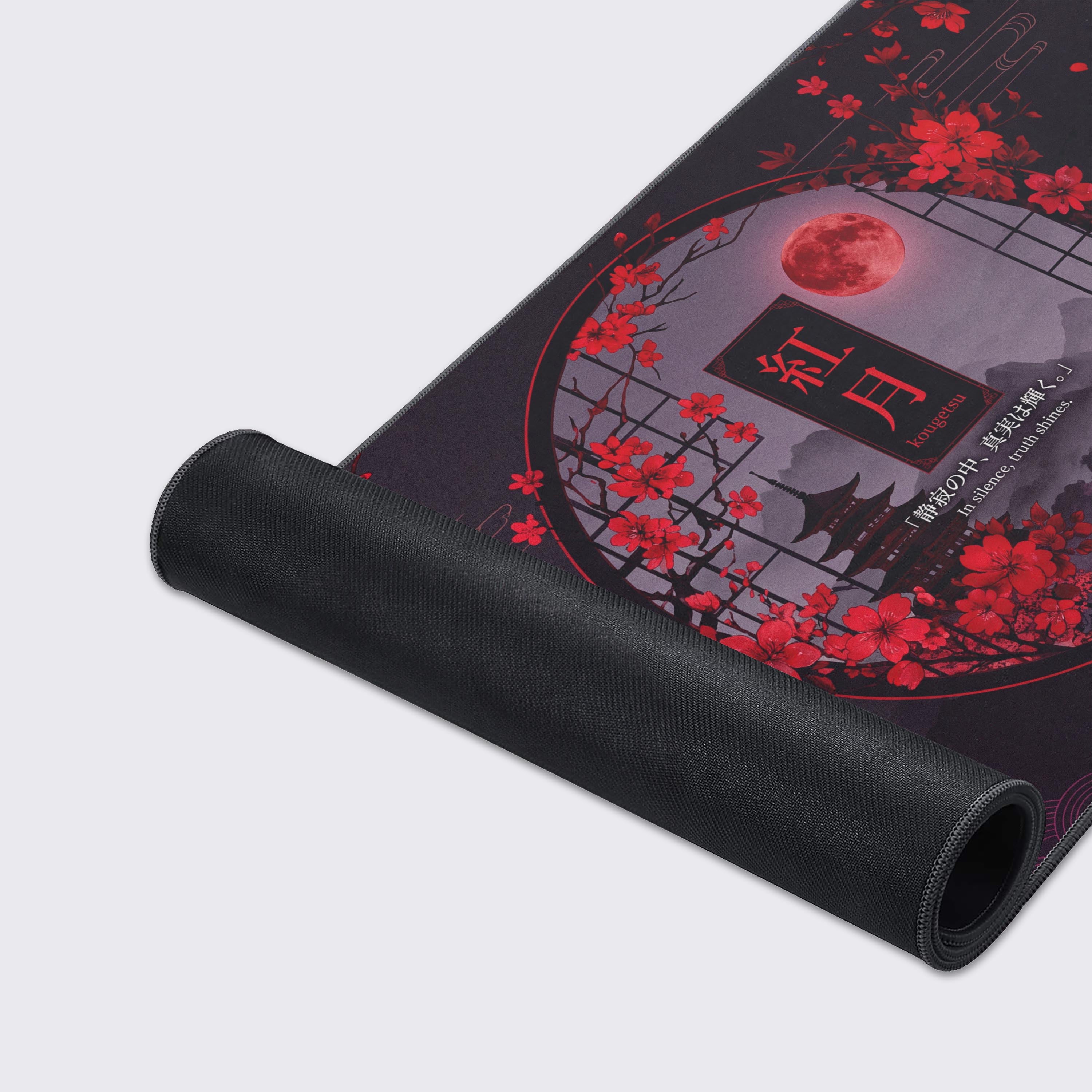 Center detail of the desk mat highlighting the brilliant red moon, intricate pagoda rooflines, and delicate sakura petals.