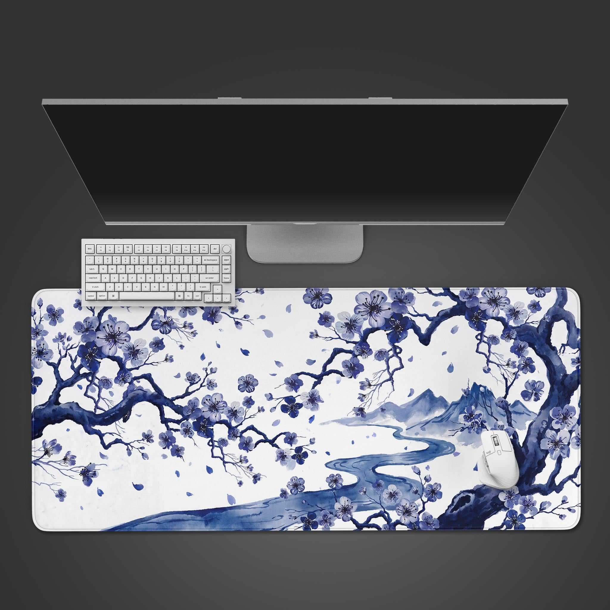 Large desk mat featuring a traditional blue ink wash painting of a blossoming tree over a winding river and mountains.