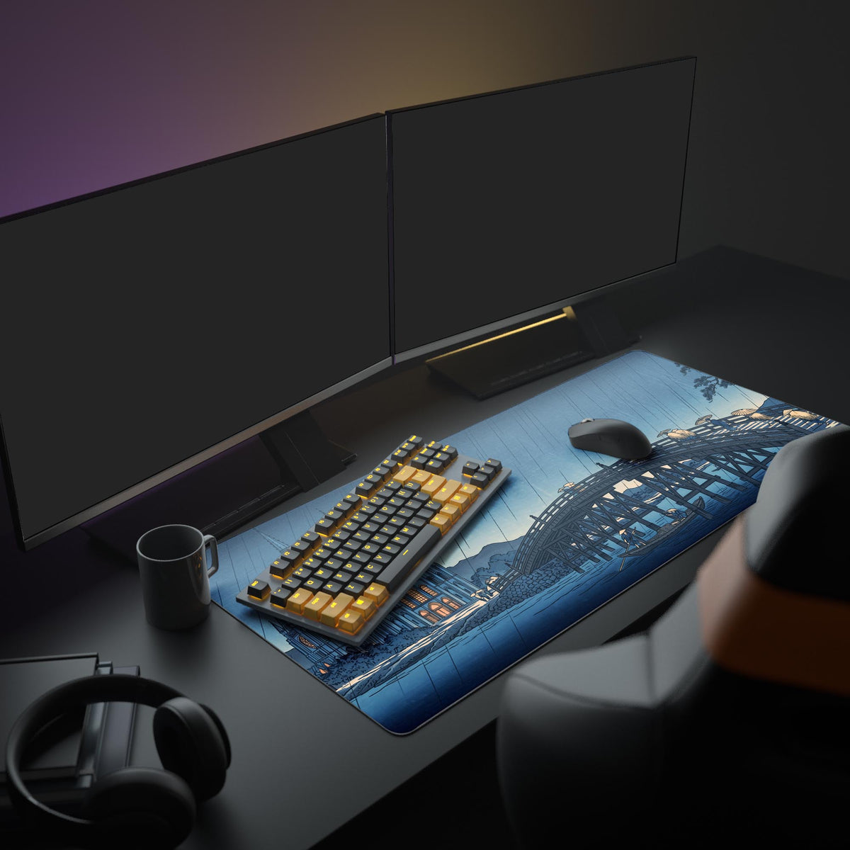Dark desk with two monitors, a mug, headphones, keyboard and mouse on the mat's rainy wooden bridge art