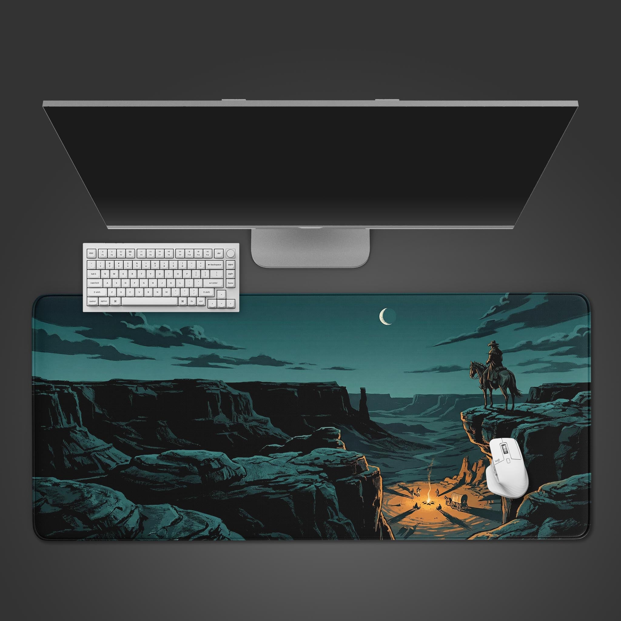 A top-down view of the Canyon Sentinel gaming desk mat featuring a cowboy overlooking a canyon, shown with a white keyboard and mouse on a dark background. - Epic Design Pads & Mousepads