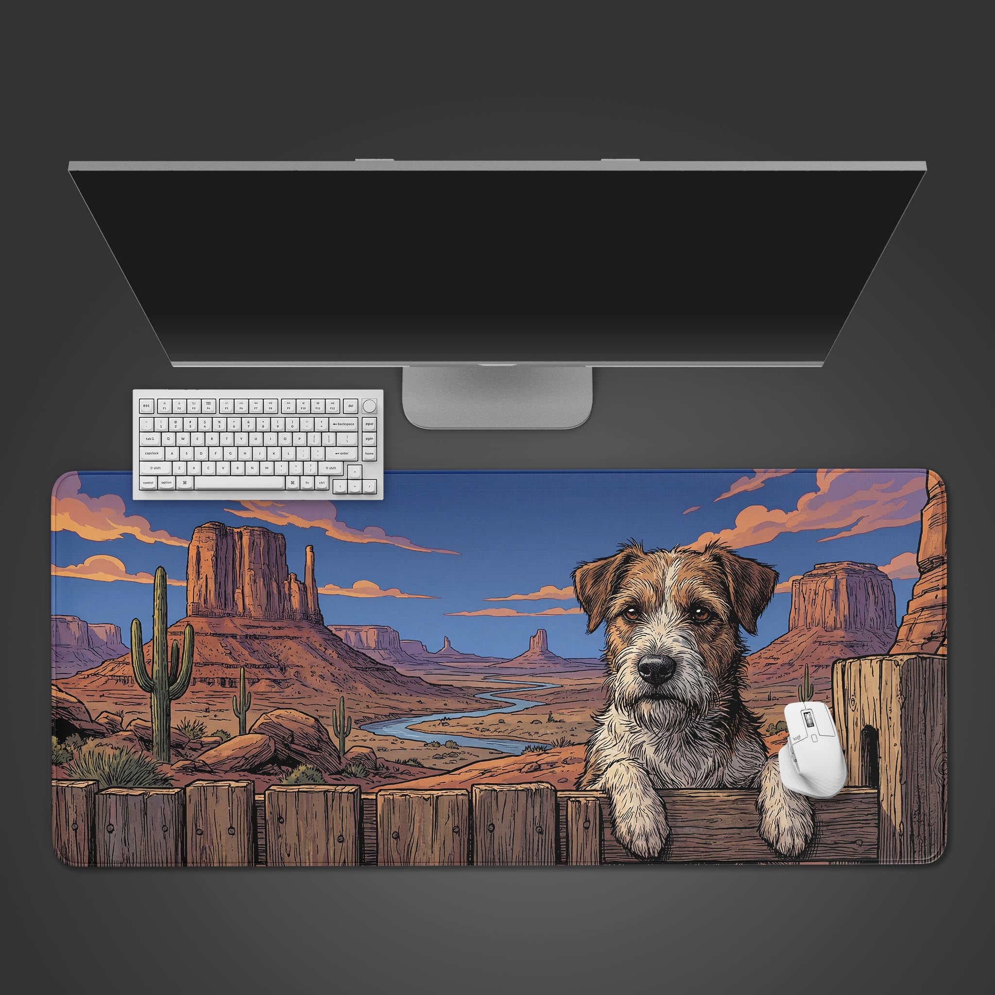 A top-down view of the Canyon Terrier gaming desk mat, featuring a comic-style dog in a desert landscape, shown with a white keyboard and mouse on a dark surface. - Epic Design Pads & Mousepads