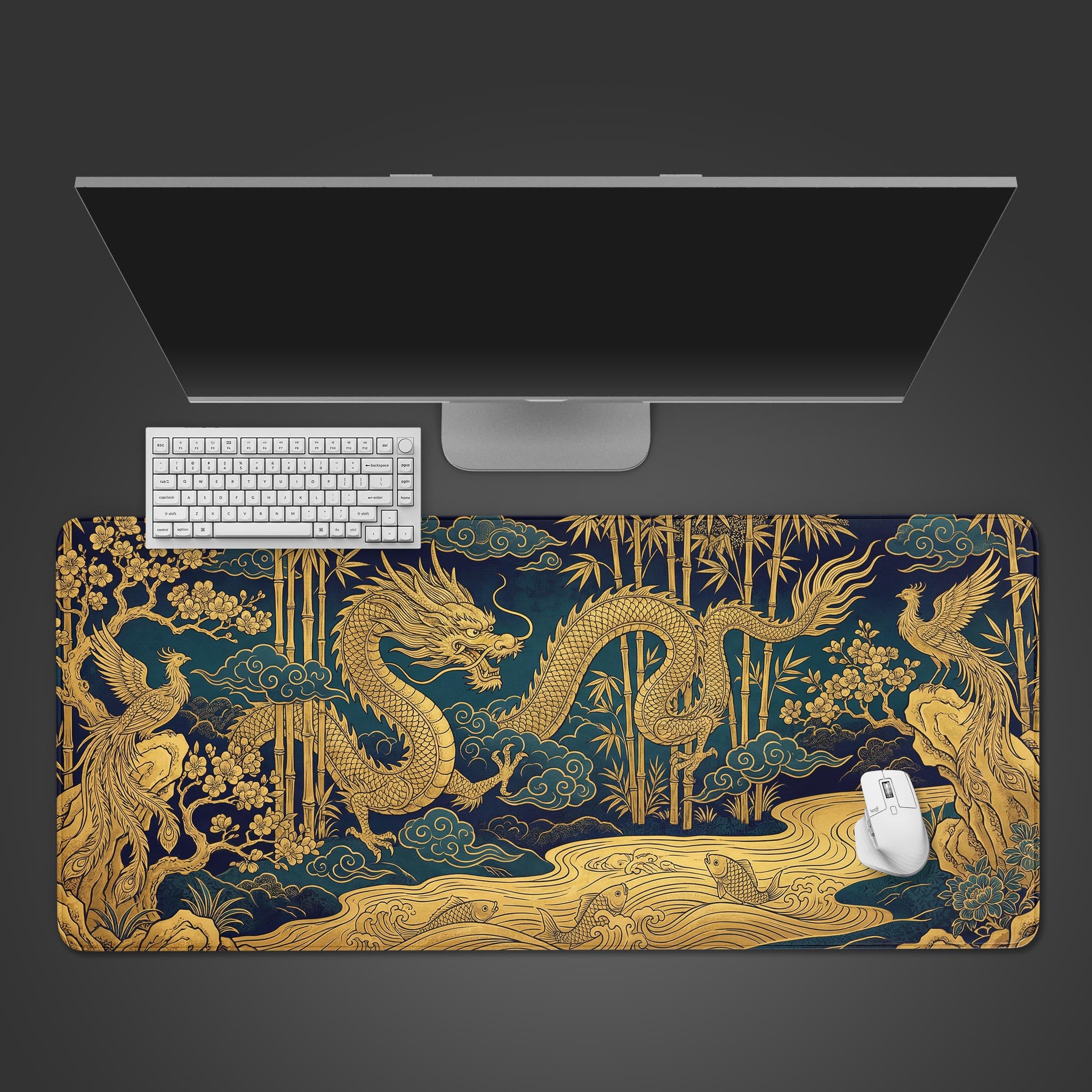 Top-down view of the Celestial Union gaming desk mat featuring a golden dragon and phoenix, shown with a white keyboard, mouse, and monitor on a dark background. - Epic Design Pads & Mousepads