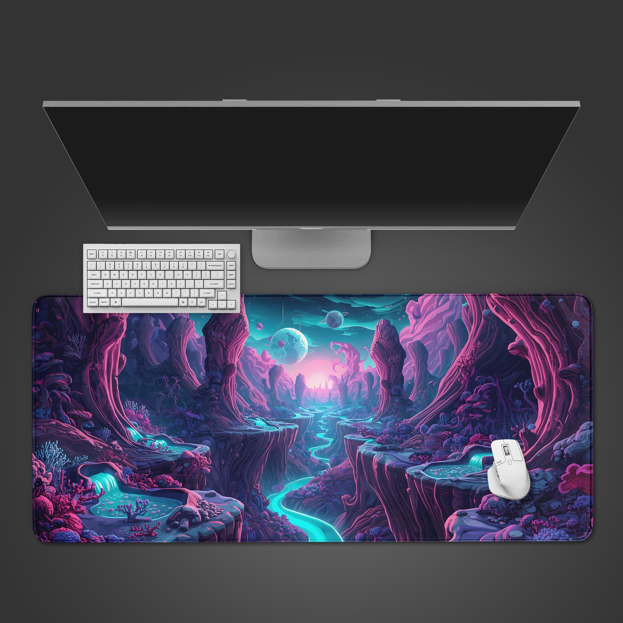 Top-down view of the Celestial Valley Gaming Desk Mat, featuring a vibrant alien landscape design with a white keyboard, mouse, and monitor on a dark background. - Epic Design Pads & Mousepads