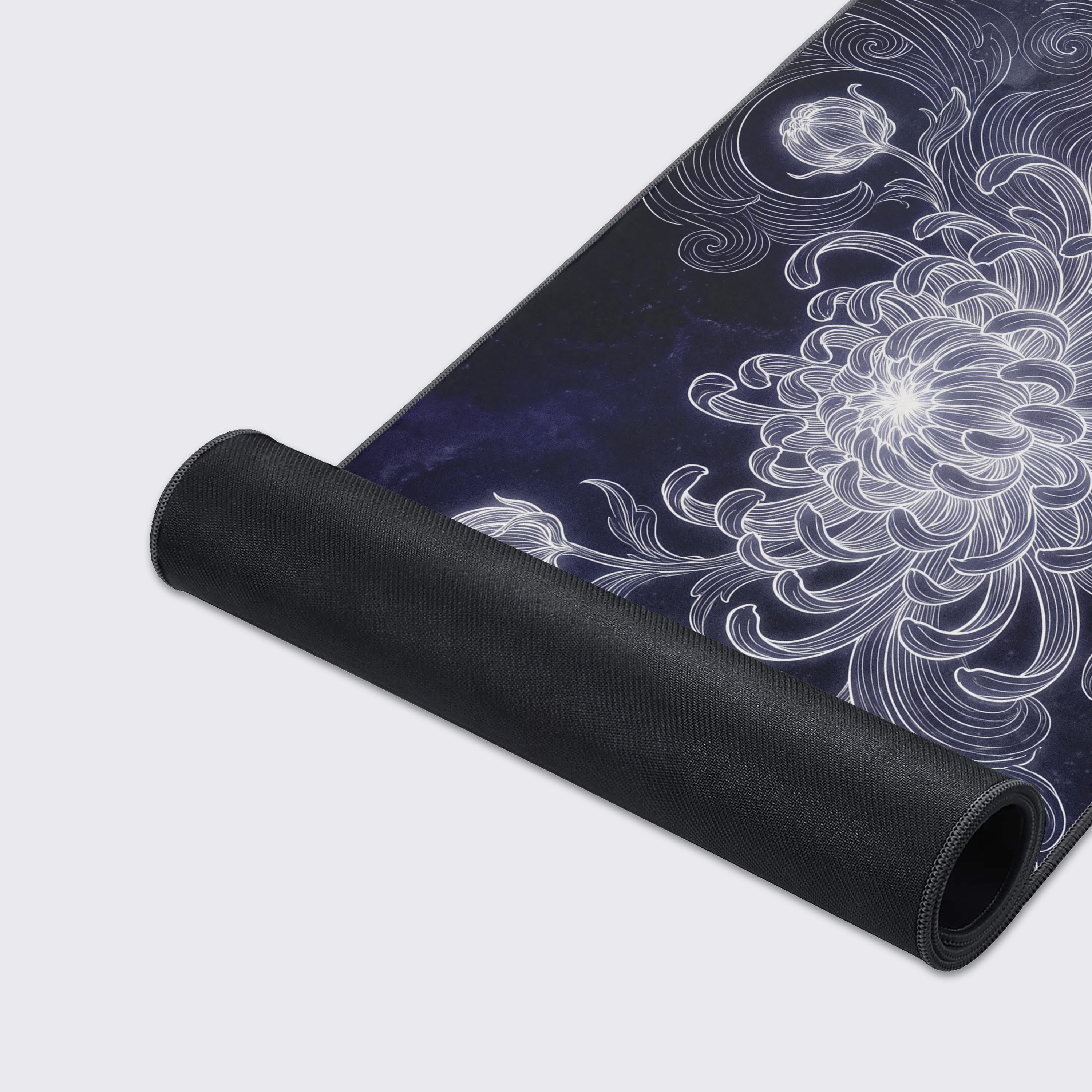 A cosmic floral desk mat floating above a reflective surface with graphic icons displayed below.