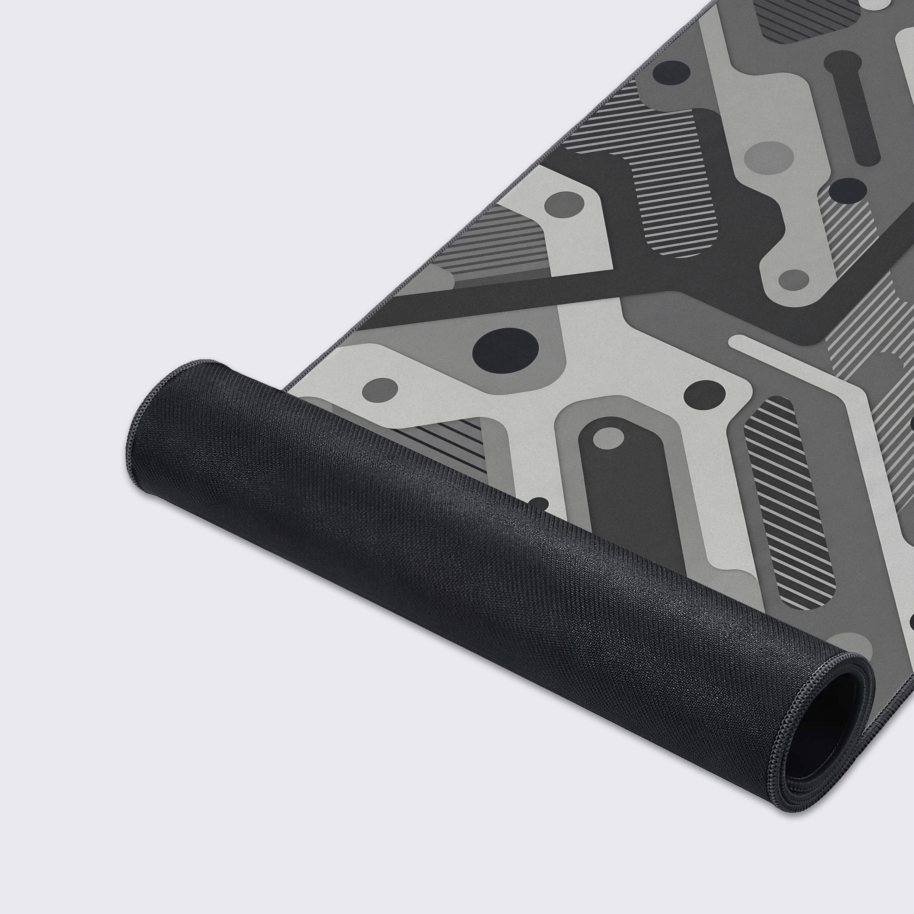 Lifestyle view of the abstract geometric desk mat elevating a modern gaming and workspace setup.