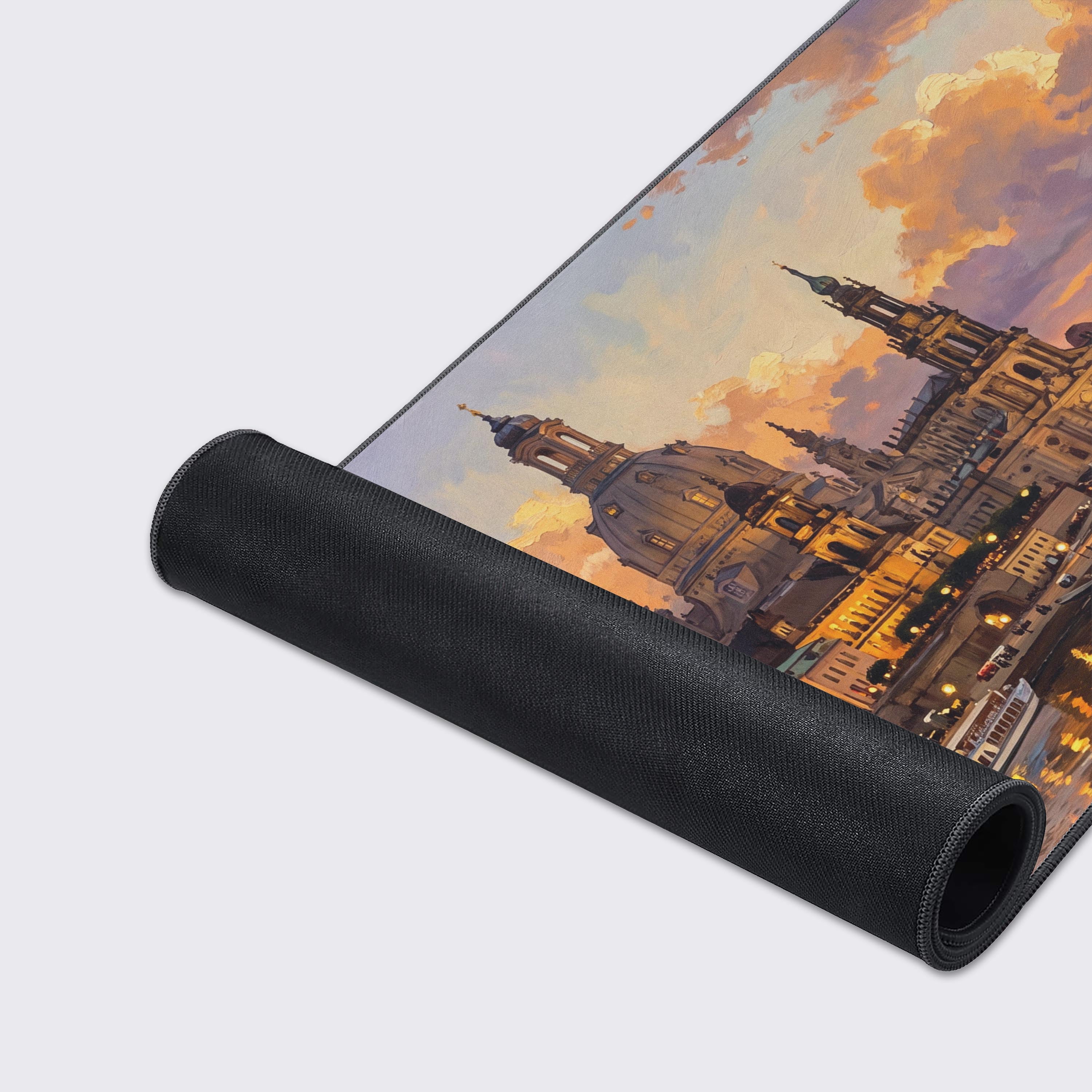 Top-down view of the cityscape desk mat highlighting the warm sunset reflections on the calm water.