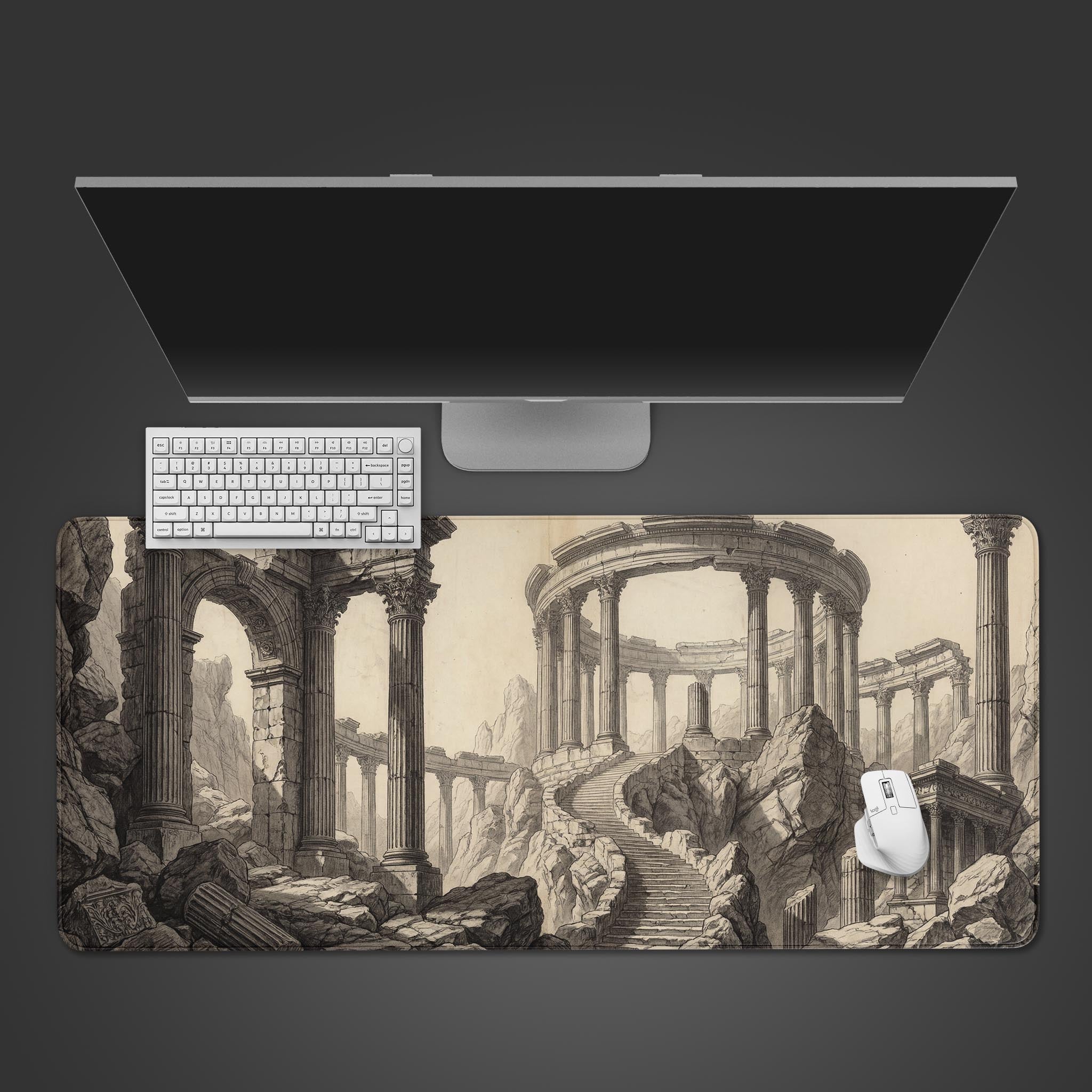 A top-down view of the Classical Decay gaming desk mat, featuring a detailed etching of ancient ruins, shown with a white keyboard and mouse. - Epic Design Pads & Mousepads