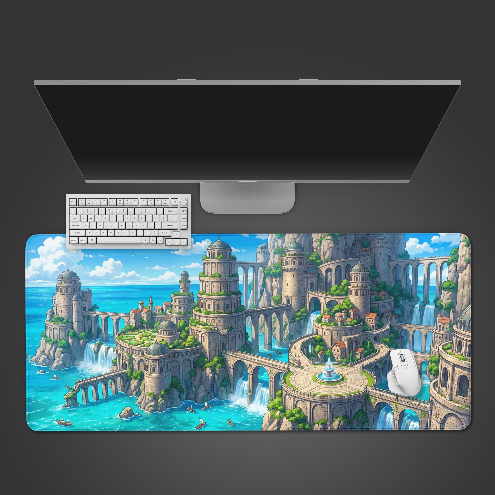 A top-down view of the Coastal Dominion gaming desk mat, showing its fantasy city design beneath a sleek monitor, keyboard, and white mouse. - Epic Design Pads & Mousepads