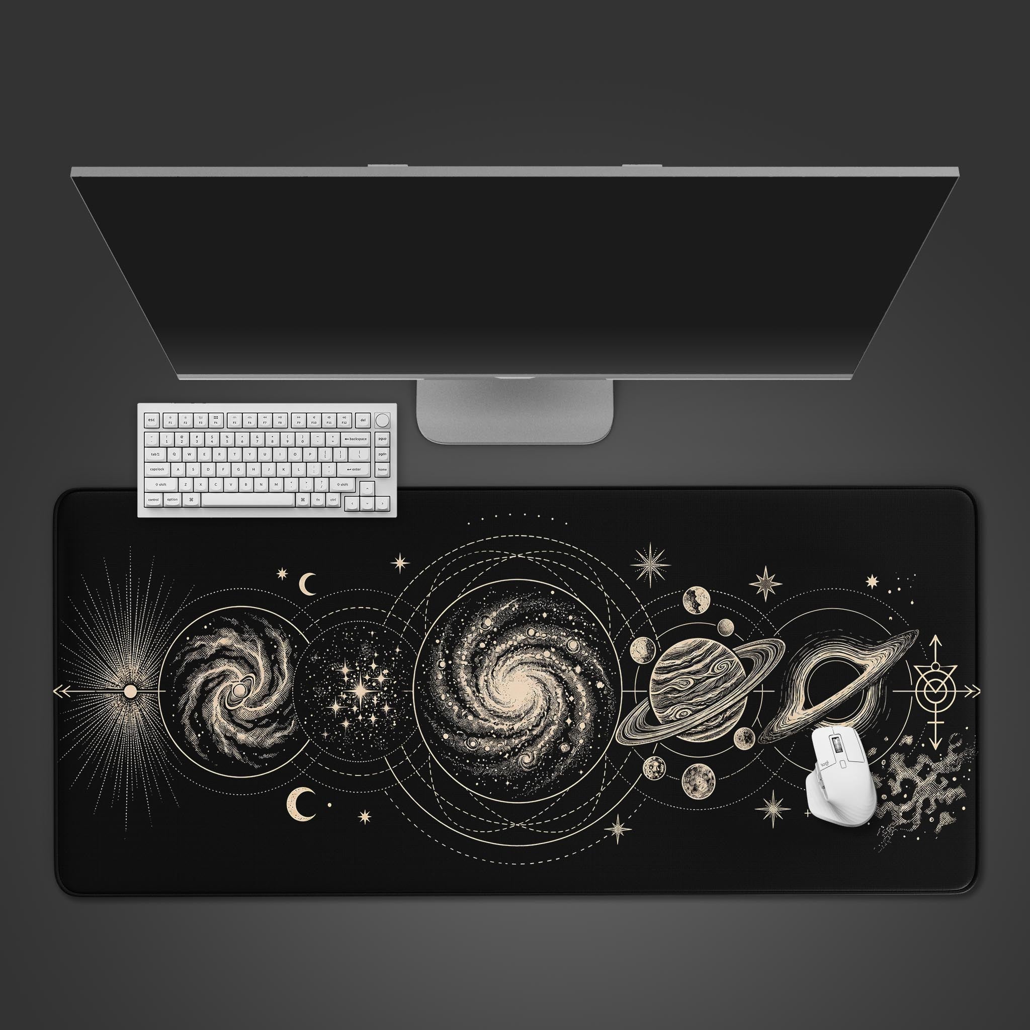 Large black desk mat featuring intricate gold line art of galaxies, planets, and celestial orbits.