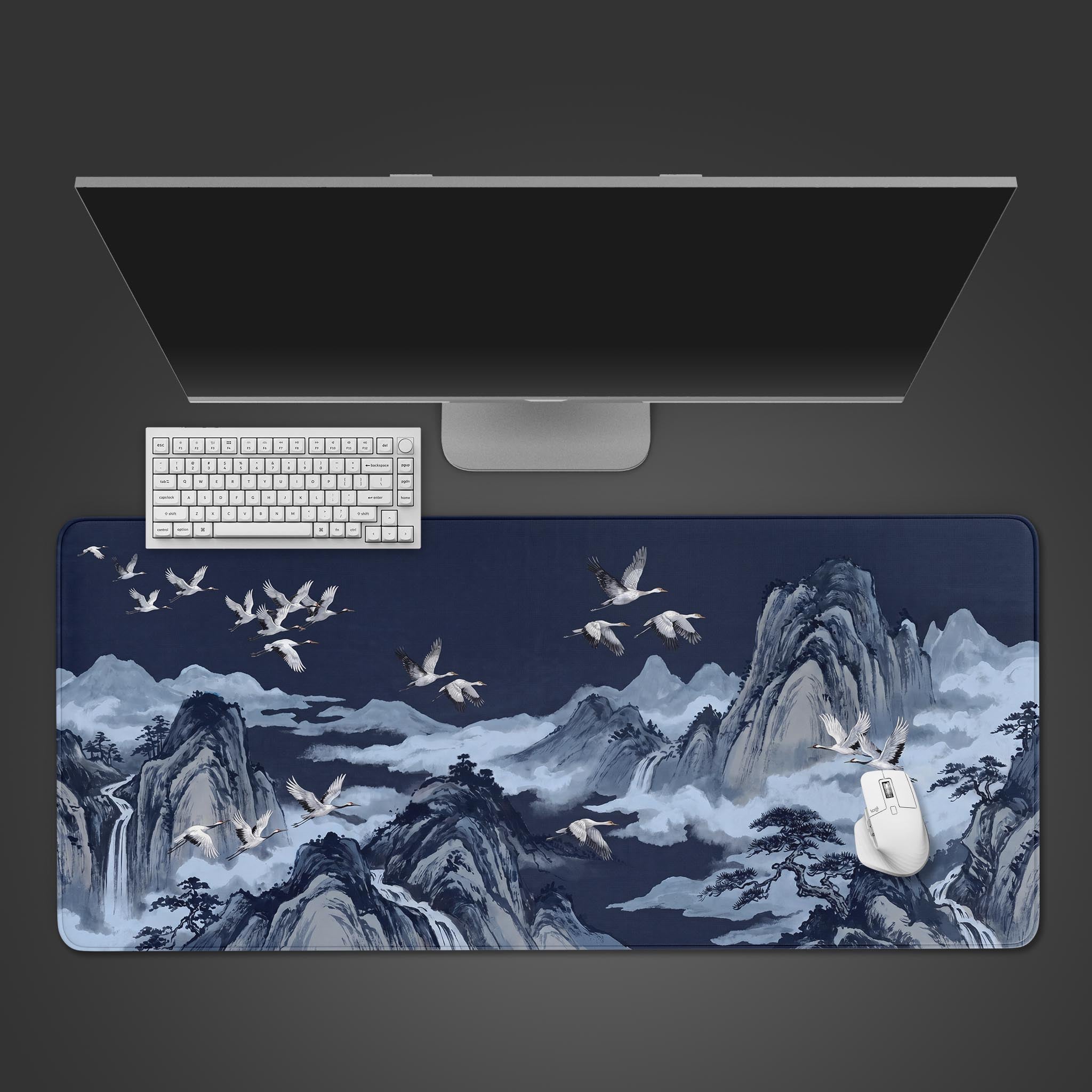 Indigo Cranes desk mat featuring traditional white cranes soaring over misty blue mountains.