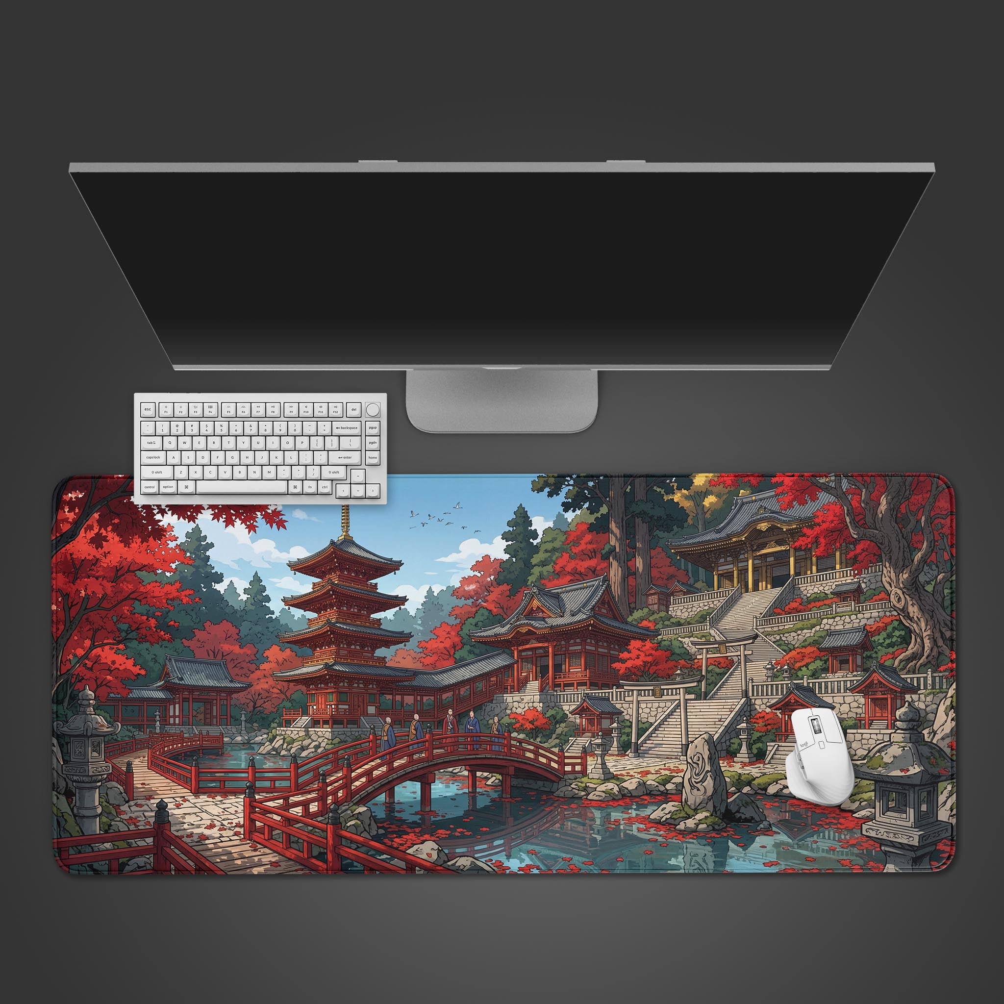 The Crimson Pagoda gaming desk mat shown from a top-down view, with a white keyboard and mouse placed on its vibrant Japanese temple and autumn leaves design. - Epic Design Pads & Mousepads