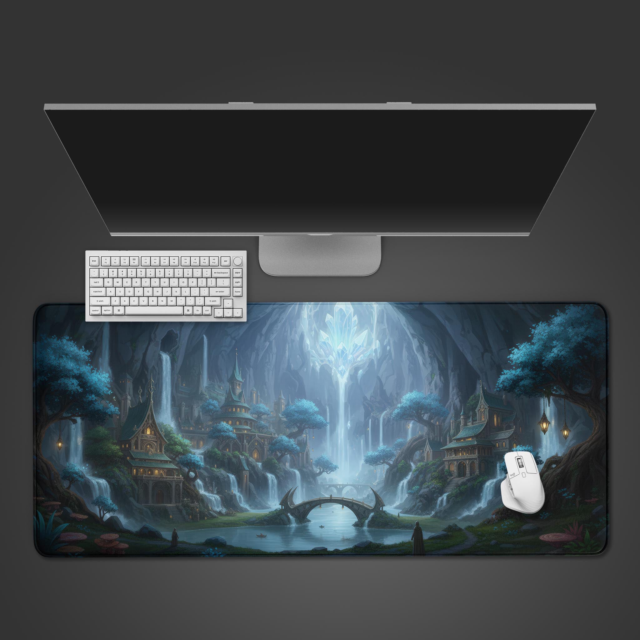 Crystal Grotto desk mat with fantasy cave city design, shown on a desk with a white keyboard and mouse. - Epic Design Pads